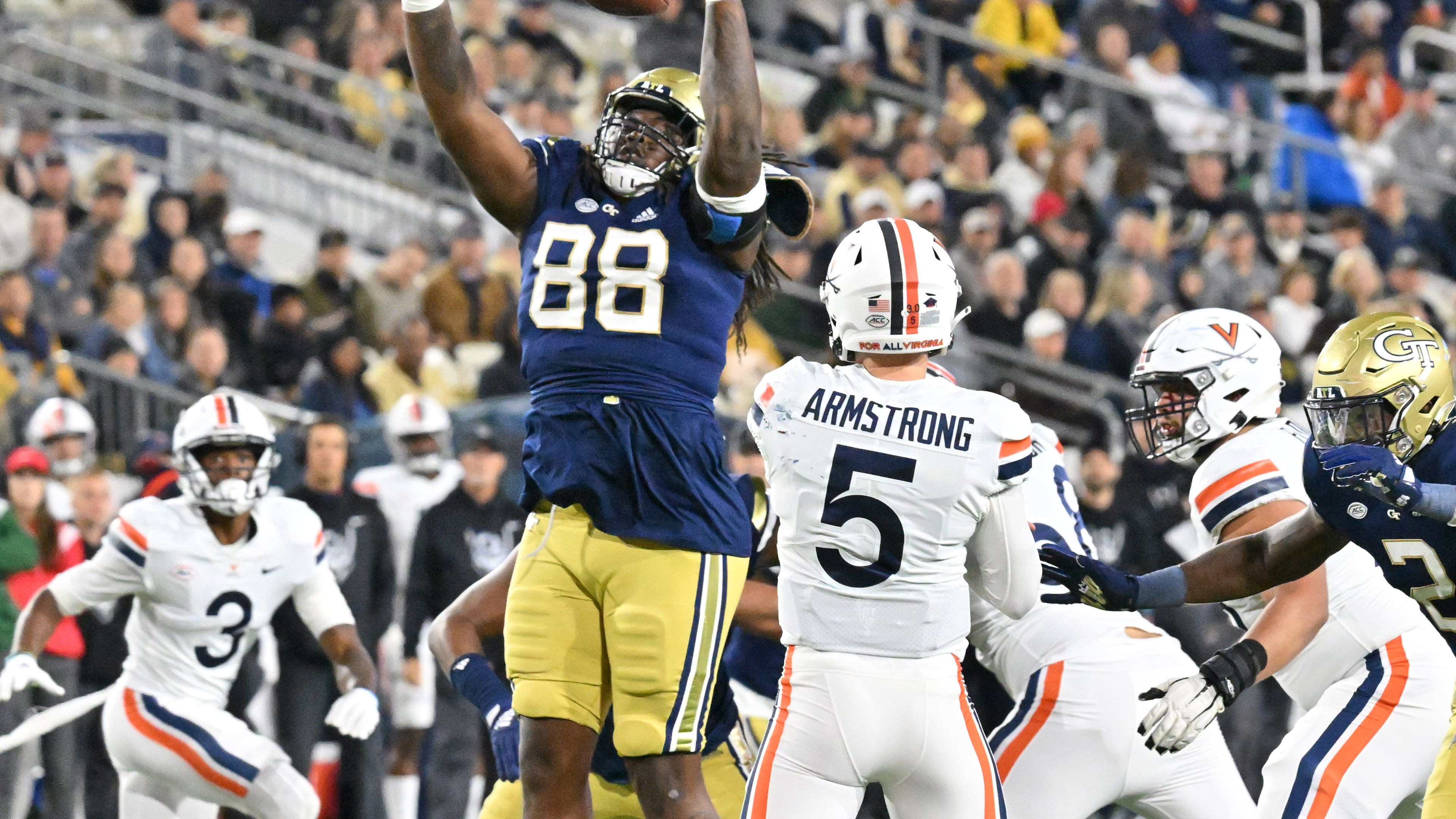 October 20, 2022 Atlanta - Georgia Tech's defensive lineman Zeek Biggers (88) blocks a pass by Virginia’s quarterback Brennan Armstrong (5) during the first half of an NCAA college football game at Georgia Tech's Bobby Dodd Stadium in Atlanta on Thursday, October 20, 2022. (Hyosub Shin / Hyosub.Shin@ajc.com)