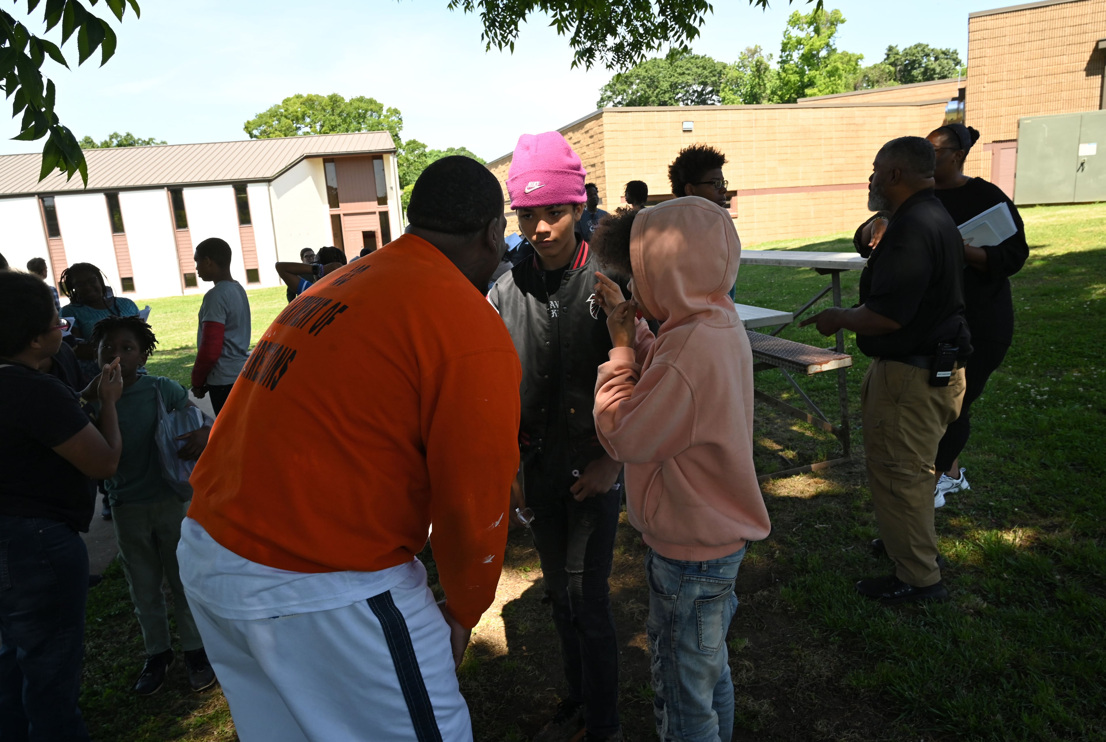 Marcus Lawson (left), an inmate at the Athens-Clarke County Correctional Institution, talks to Eli Burgess (center), 13, and Jayden Burgess, 14, after the brothers toured the prison Saturday, May 16, 2026, in Athens. (Hyosub Shin/AJC)
