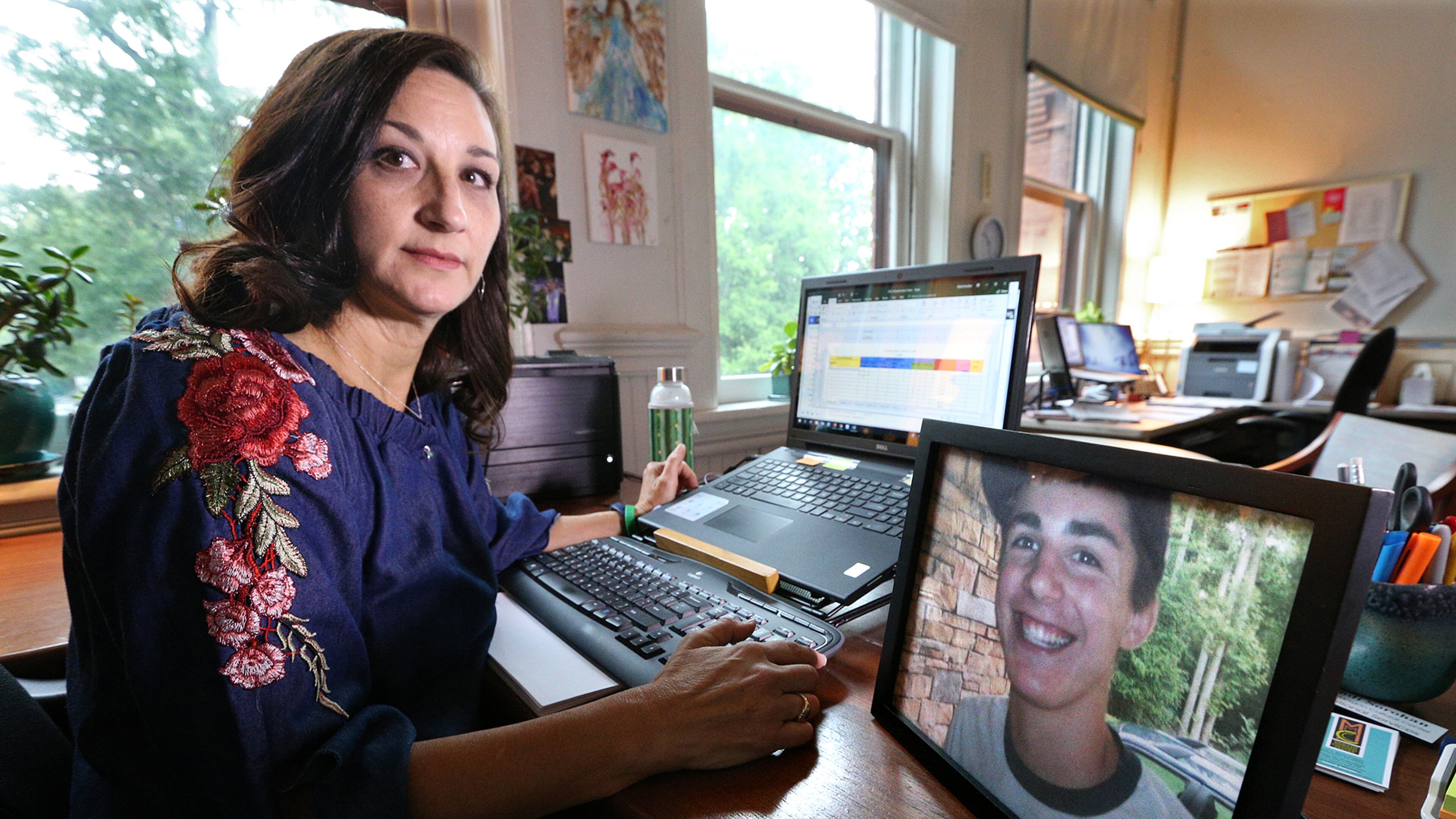 June 28, 2018 Madison: Mandi Sorohan sits next to a picture of her son, Caleb, during an interview in her office on Thursday, June 28, 2018, in Madison. Sorohan has been fighting for tougher distracted driving laws in Georgia since Caleb died in an accident while texting in 2009. Curtis Compton/ccompton@ajc.com