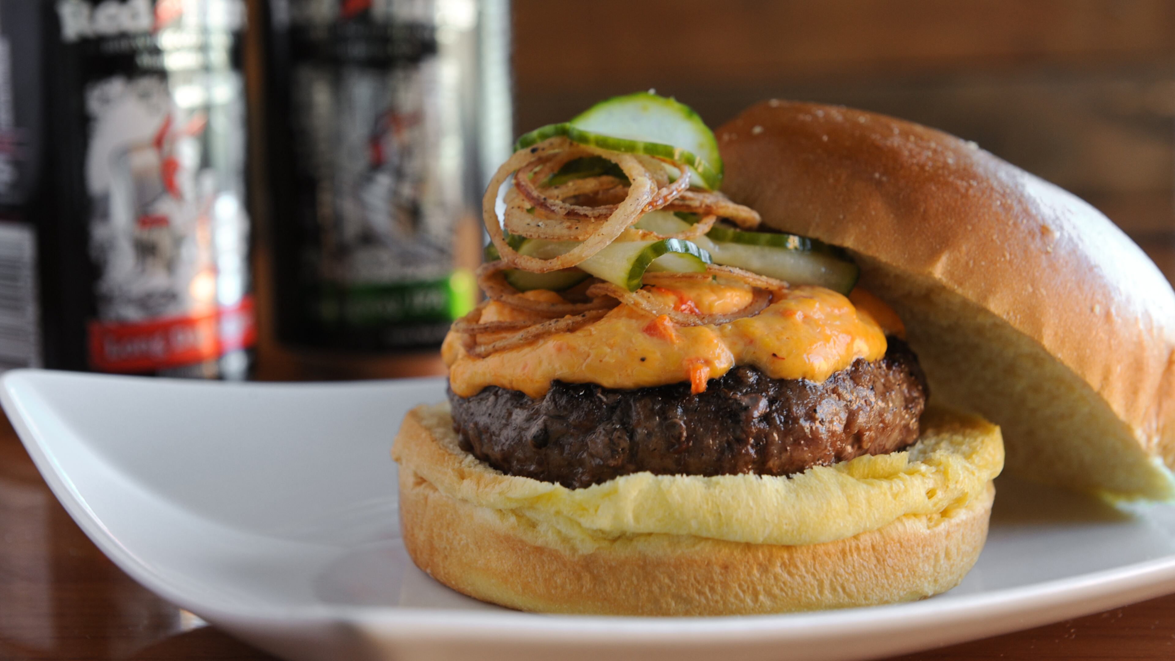 The Clayton Burger - with pimento cheese, house pickles and crispy shallots, served with Red Hare beer at Hoof & Ale. / (BECKY STEIN)