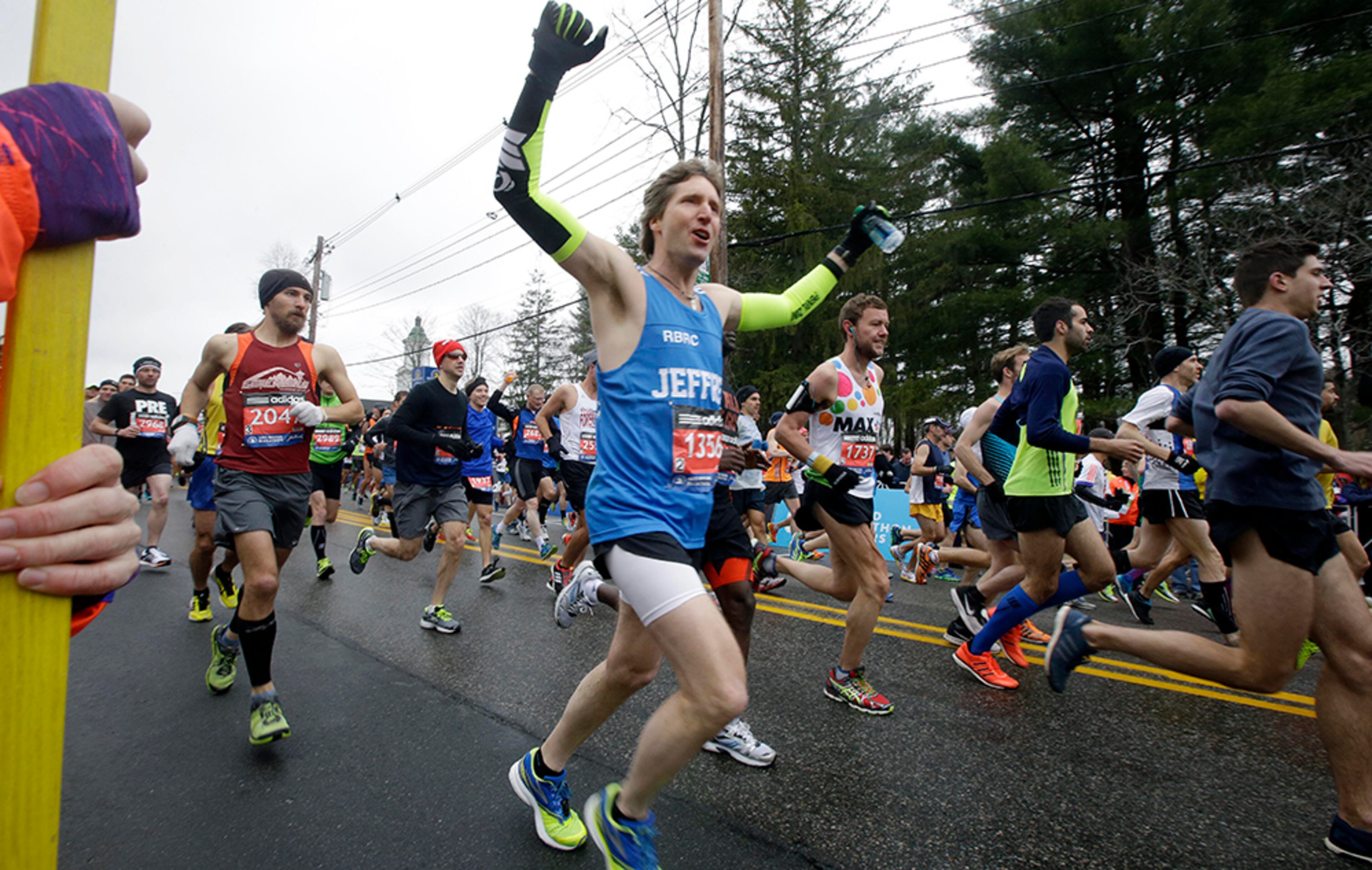 Runners, including Jeffrey Martin, center, of Edmonds, Wash., start the Boston Marathon, Monday, April 20, 2015, in Hopkinton, Mass.