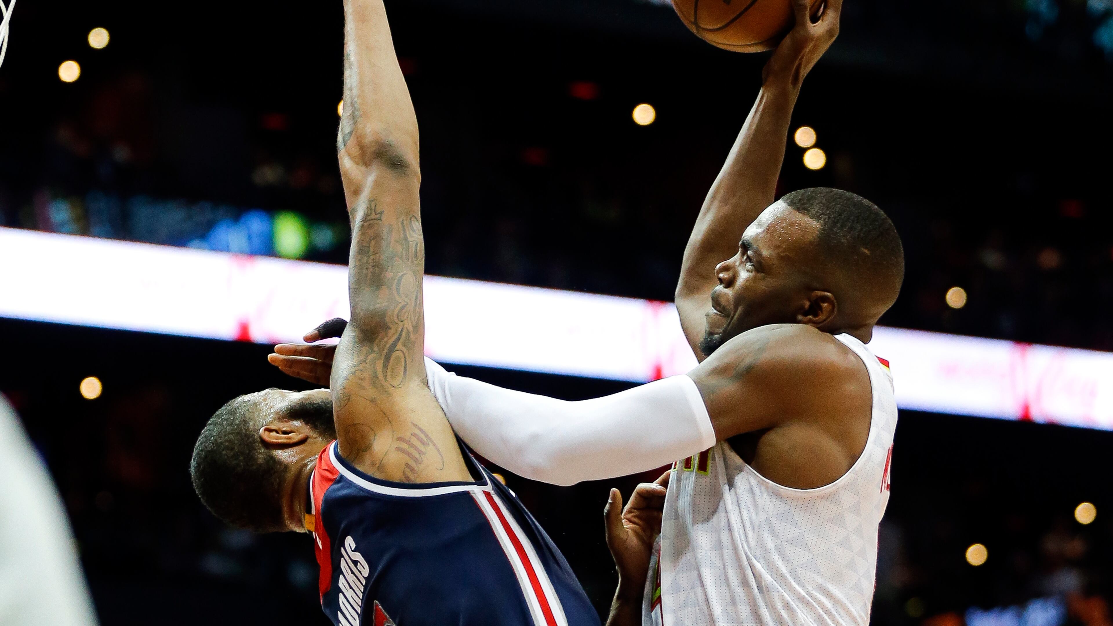 Atlanta Hawks forward Paul Millsap (4) goes to the basket against Washington Wizards forward Markieff Morris (5) during the first half of an NBA playoff basketball game Saturday, April 22, 2017, in Atlanta. (AP Photo/John Bazemore)