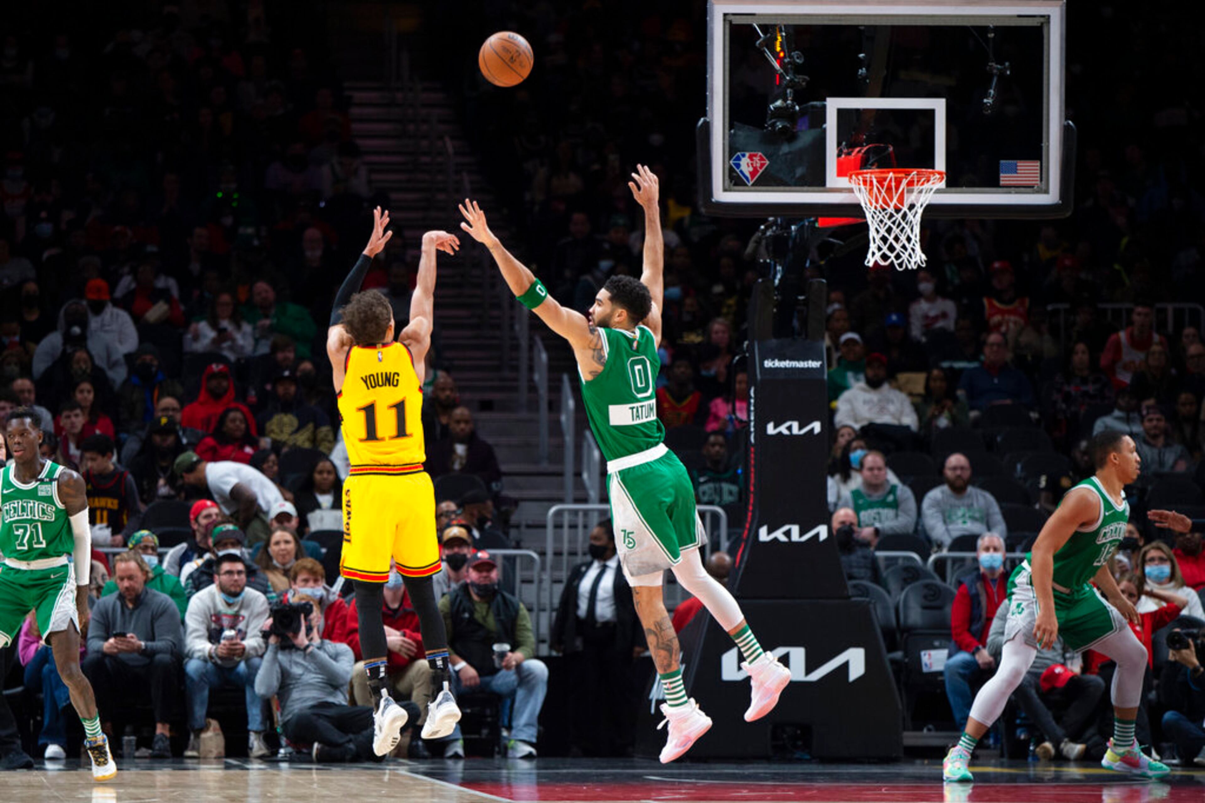 Atlanta Hawks guard Trae Young (11)shoots over Boston Celtics forward Jayson Tatum (0) during the first half of an NBA basketball game Friday, Jan. 28, 2022, in Atlanta. (AP Photo/Hakim Wright Sr.)