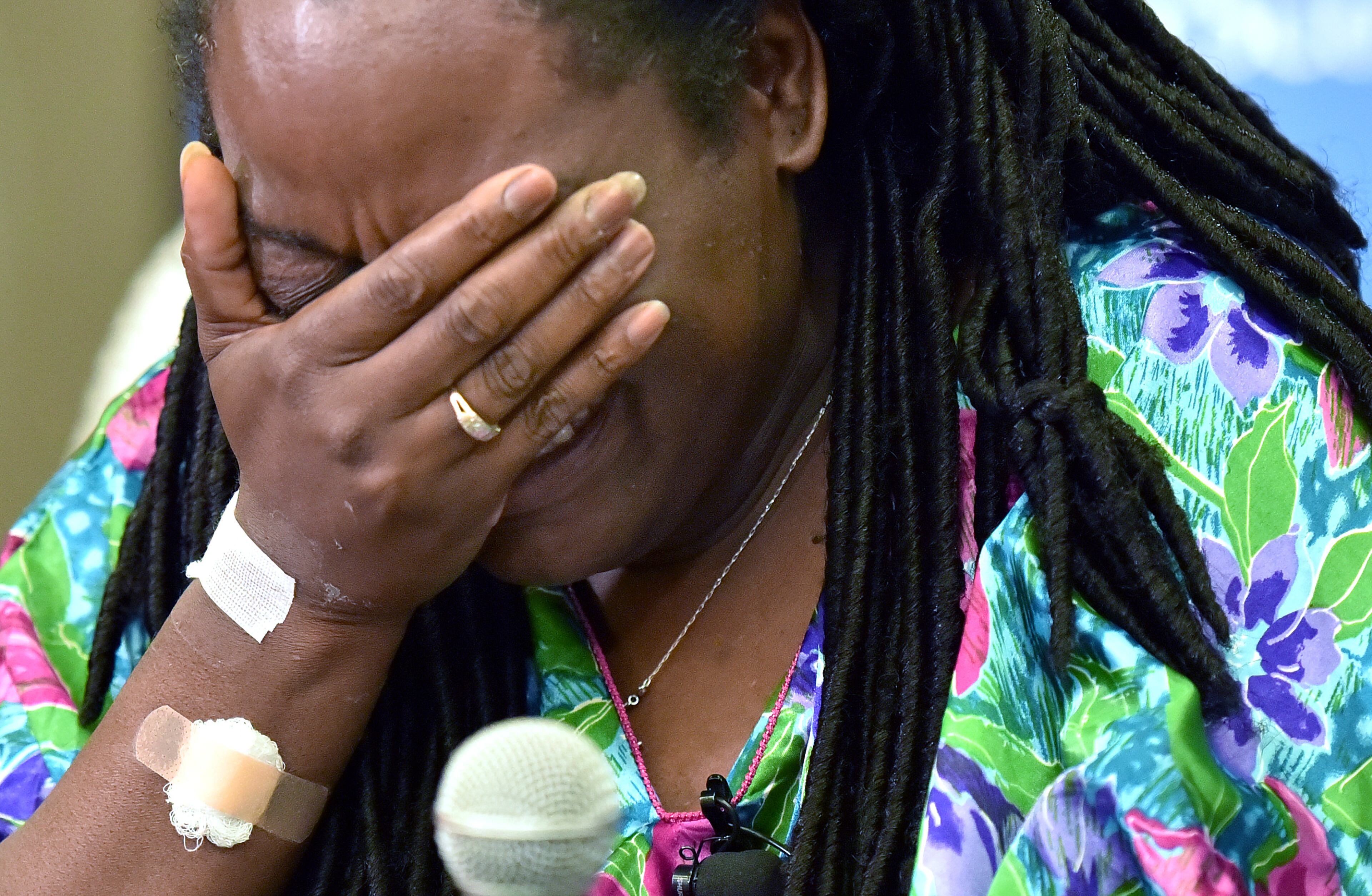 July 10, 2016 Dallas, Texas - Dallas shooting survivor Shetamia Taylor breaks down as she recalls during a press conference at Baylor University Medical Center on Sunday, July 10, 2016. Shetamia Taylor, 37, risked her life to protect her 15-year-old son as chaos broke out in Dallas Thursday night when a sniper opened fire after an otherwise peaceful protest, killing five law enforcement officers. HYOSUB SHIN / HSHIN@AJC.COM