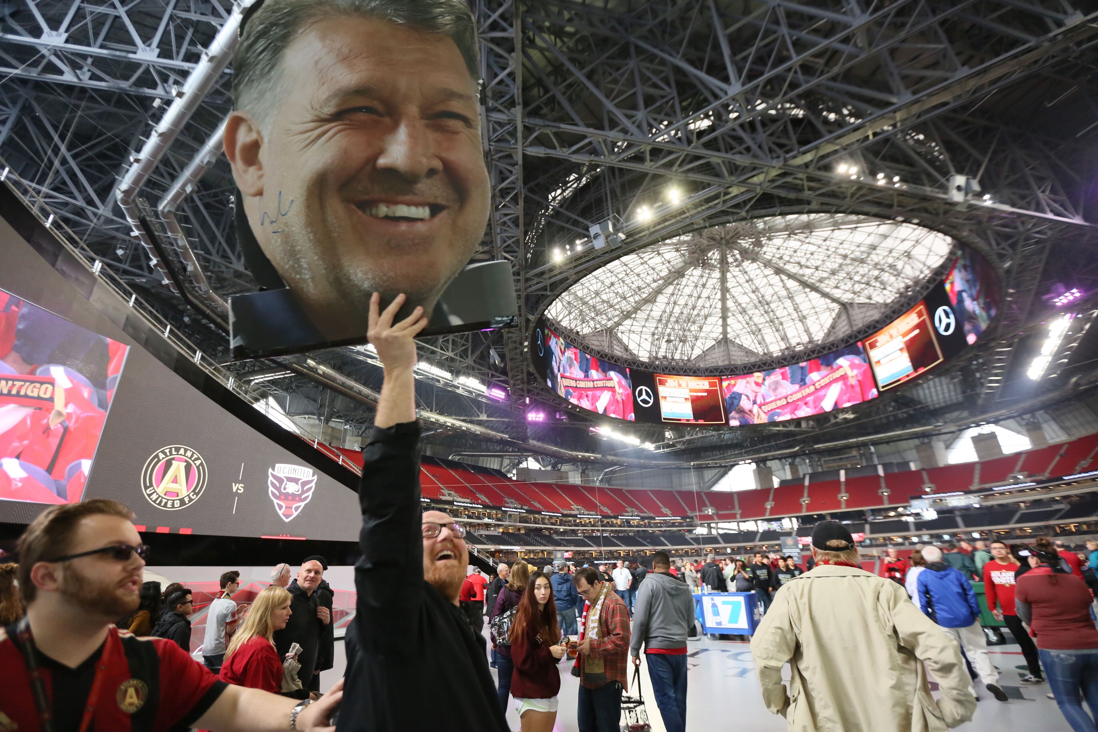 March 11, 2018. A founding member Tim Tewell from East Cobb shows his support to the Atlanta United holding a 'Tata' Martino banner from the 100 concourse ins of the Mercedes-Benz stadium on March 11, 2018 in Atlanta Ga.