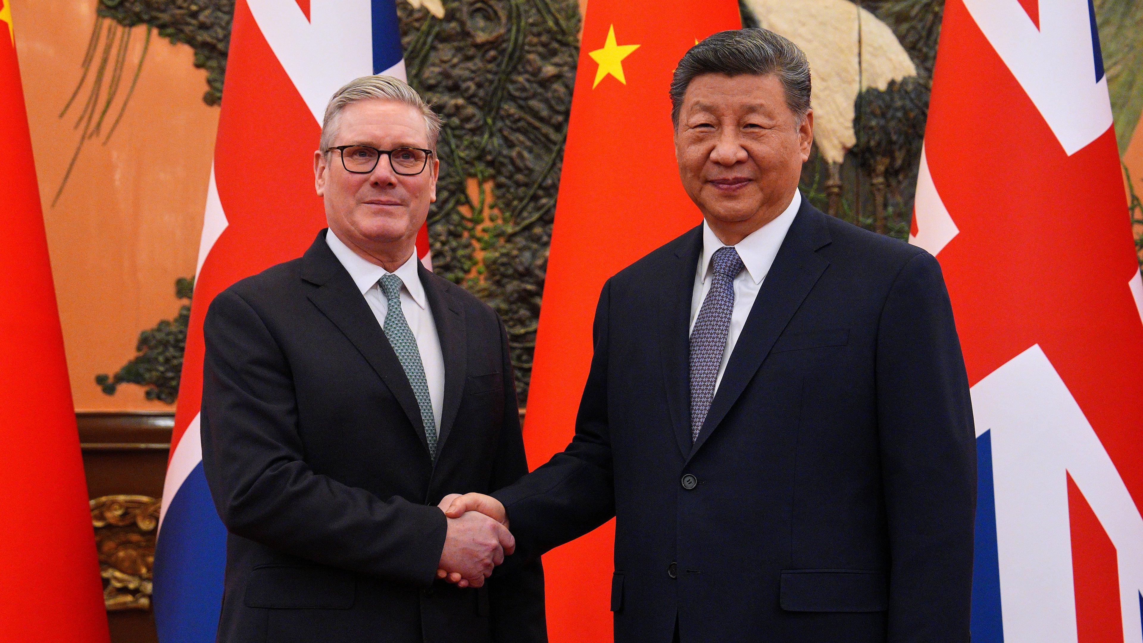 Britain's Prime Minister Keir Starmer, left, shakes hands with Chinese President Xi Jinping ahead of a bilateral meeting in Beijing, China, Thursday, Jan.29, 2026. (Carl Court/Pool Photo via AP)