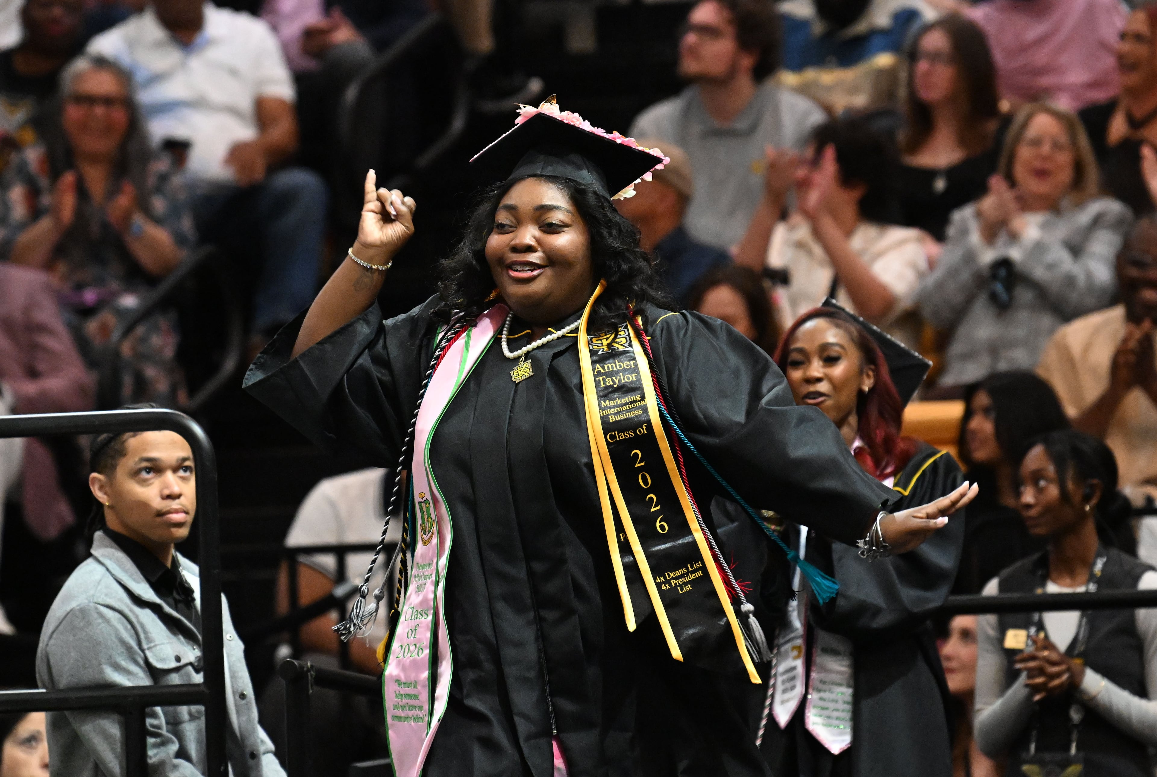 Amber Taylor is practically dancing as she walks onto the stage to receive her diploma. (Hyosub Shin/AJC)