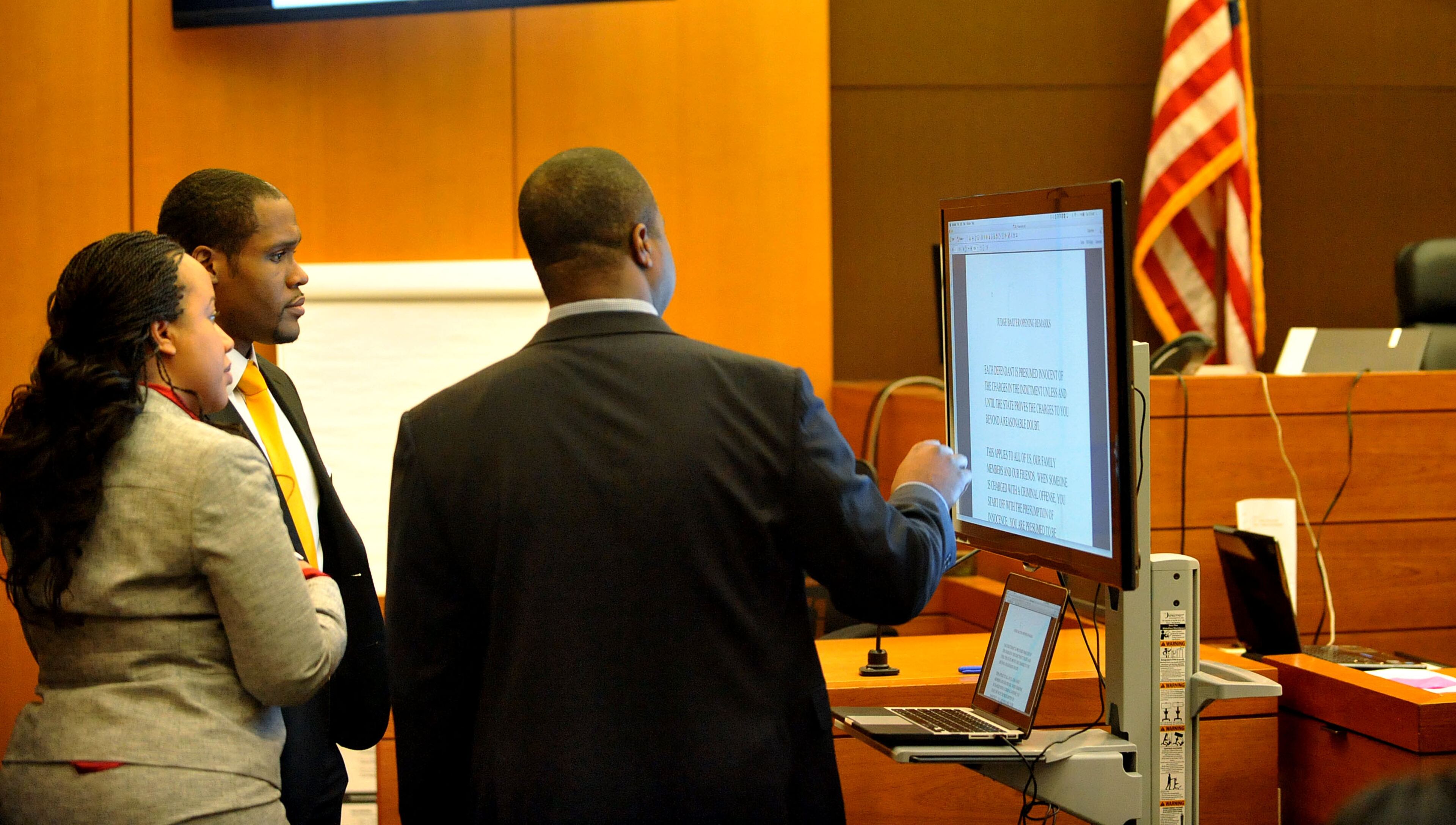 Defense attorney Benjamin Davis prepares his closing statement as fellow defense attorneys Annette Greene and Gerald Griggs look over the presentation Tuesday. (Atlanta Journal-Constitution, Kent D. Johnson, Pool)