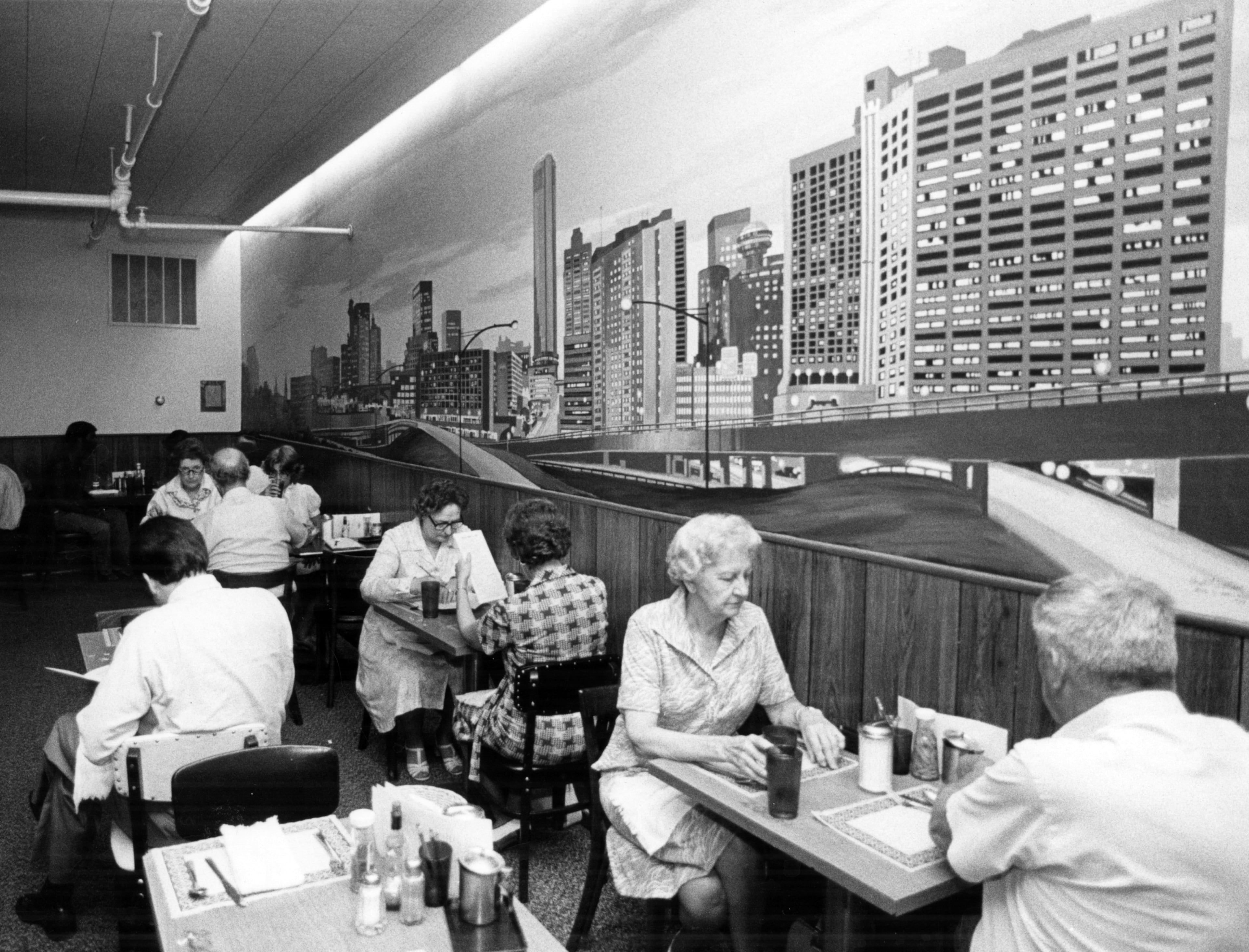 This is the non-smoking section of Mary Mac's, back in 1979 when people smoked inside restaurants, with a mural of the Atlanta skyline on the wall.
