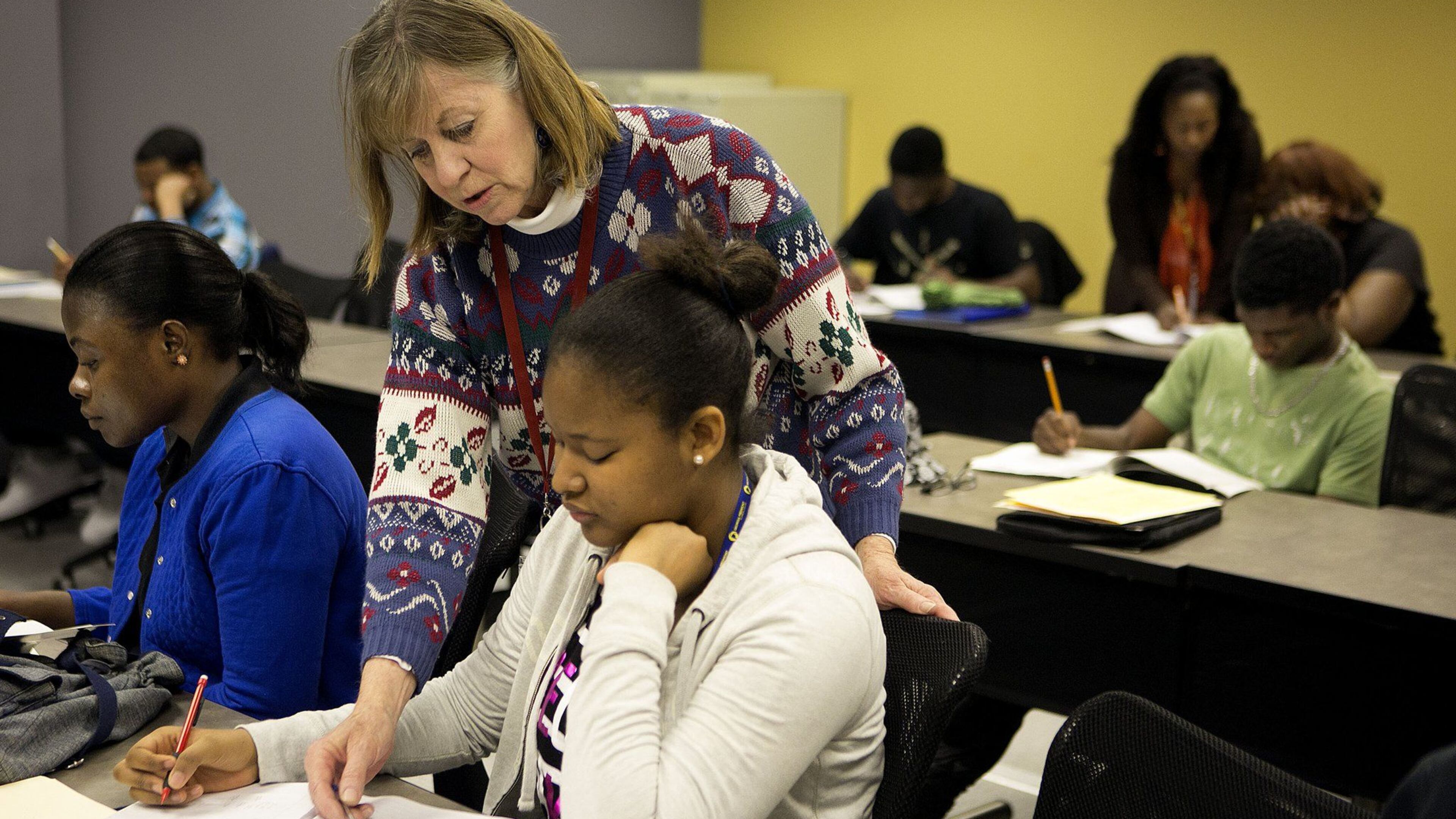 Instructor Margaret Robling (standing) helps Isatu Jalloh (right) during a GED preparation class at Georgia Piedmont Technical College. Georgia Piedmton is part of the Technical College System of Georgia, which has started a new program to help more adults without a high school diploma get their credentials. PHOTO CONTRIBUTED.