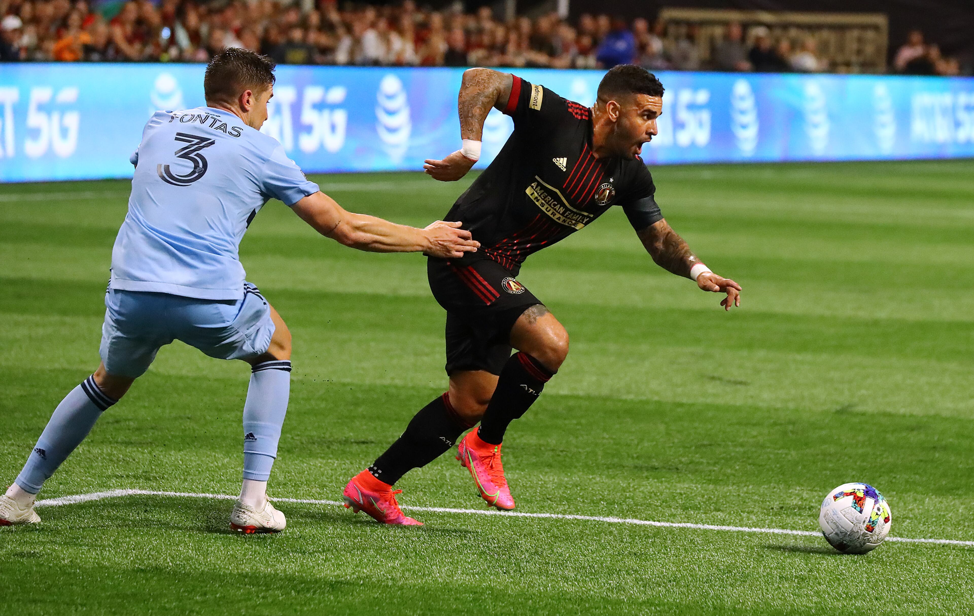 022722 : Atlanta United's Dom Dwyer gets past Sporting KC defender Andreu Fontas to score a goal for a 2-0 lead in an MLS soccer match on Sunday, Feb. 27, 2022, in Atlanta. “Curtis Compton / Curtis.Compton@ajc.com”`