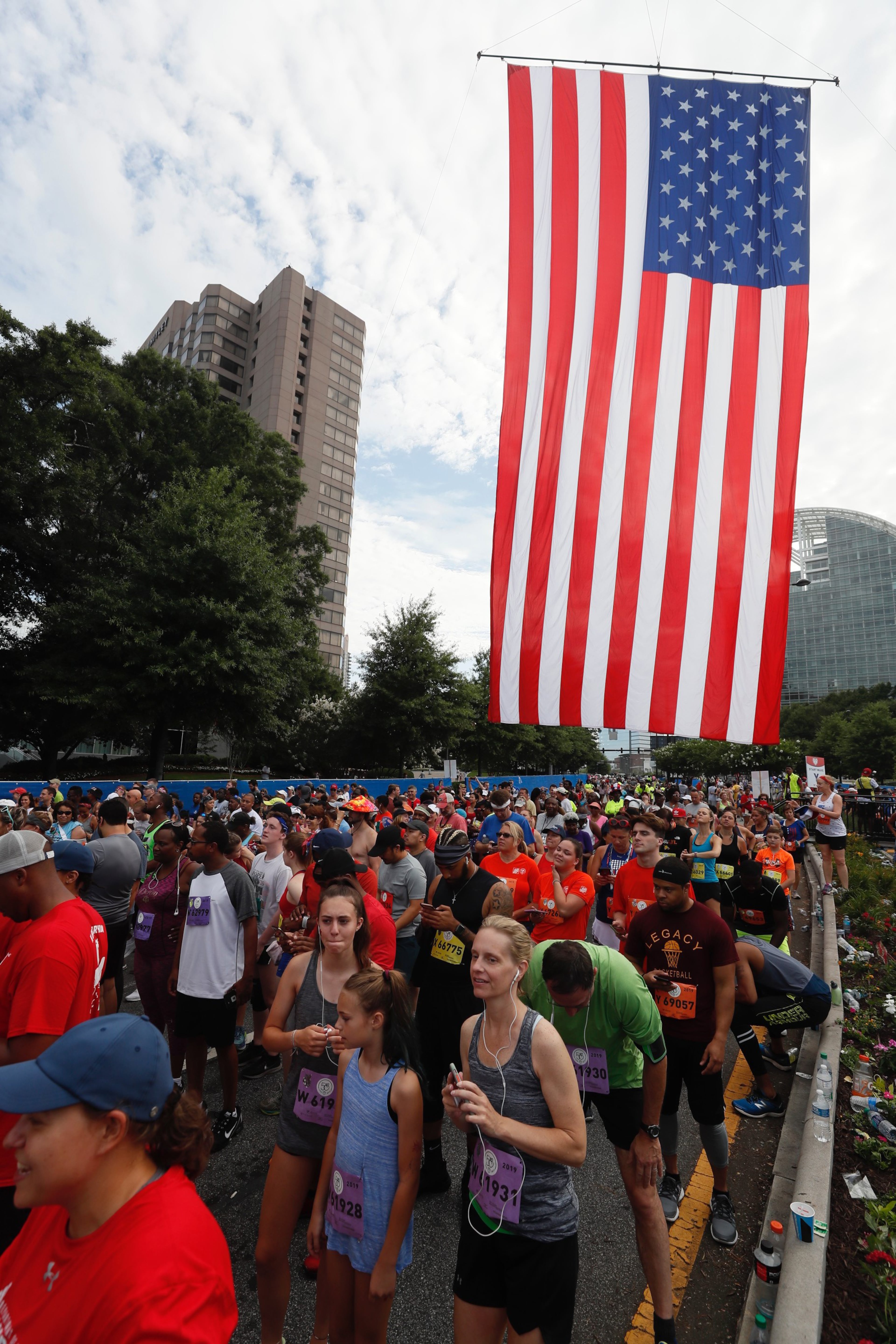 The final group races to the finish line at the AJC Peachtree Road Race on Thursday, July 4, 2019.