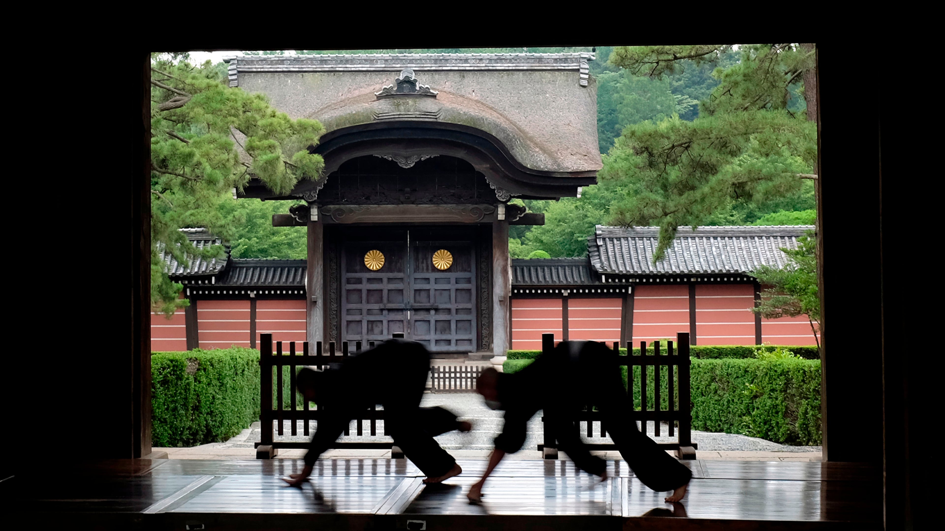 FILE - Monks polish the wooden corridor of the walkway that connects between temple buildings at Soji-ji in Yokohama, Japan on July 5, 2016. (AP Photo/Kiichiro Sato, File)