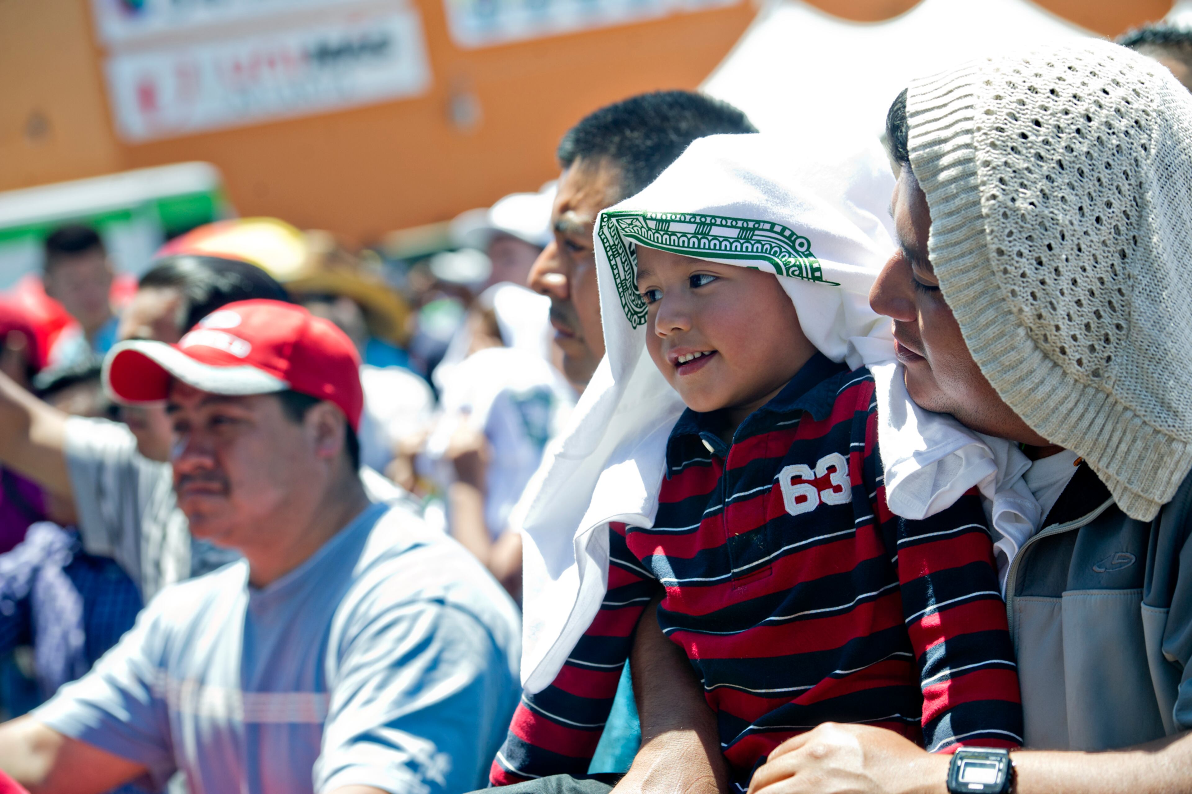 Jesus Abilz (left) and his father Jose watch La Fe de Nuevo Leon perform on stage during the Cinco de Mayo Festival at Plaza Fiesta in Atlanta on Sunday, May 4, 2014.
