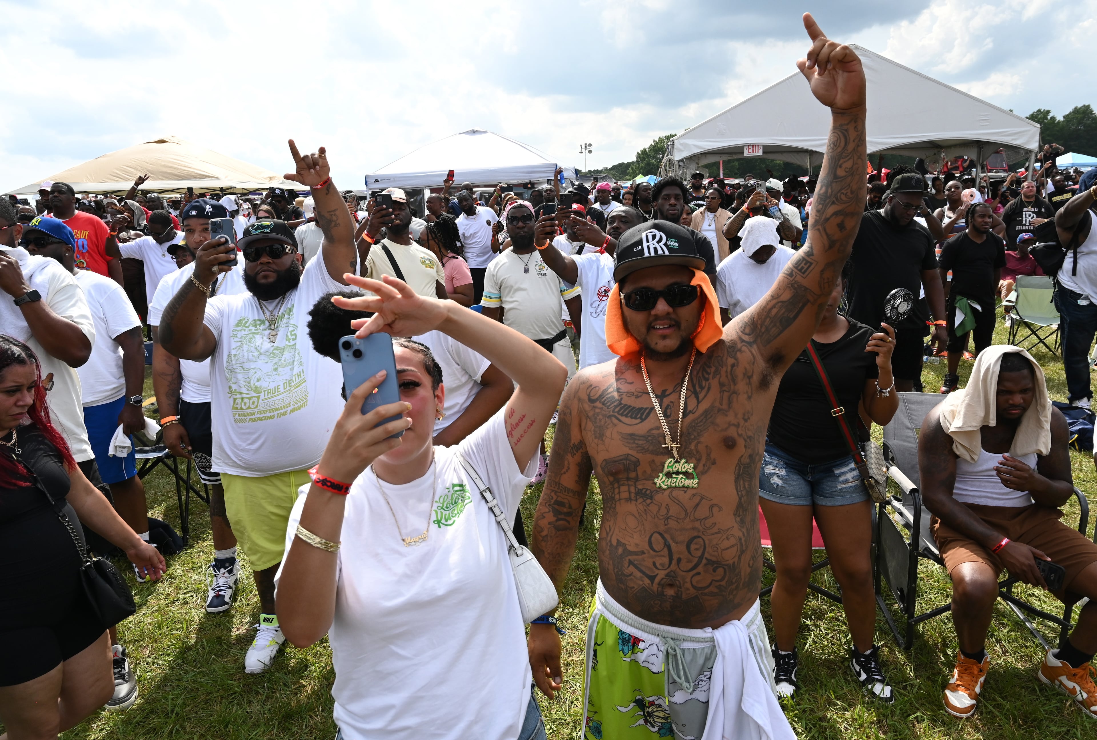 Attendees enjoy a live music performance by Rick Ross during the 4th Annual Rick Ross Car and Bike Show, Saturday, June 7, 2025, in Fayetteville. The 4th Annual Rick Ross Car and Bike Show will include a vendor market with more than 30 vendors, food trucks, fleets of classic/custom automobiles, luxury vehicles, boats, RVs and trailers on the front of the mansion. Stage performances include Plies, Ross' new signee Nino Breeze and Ross himself. (Hyosub Shin / AJC)