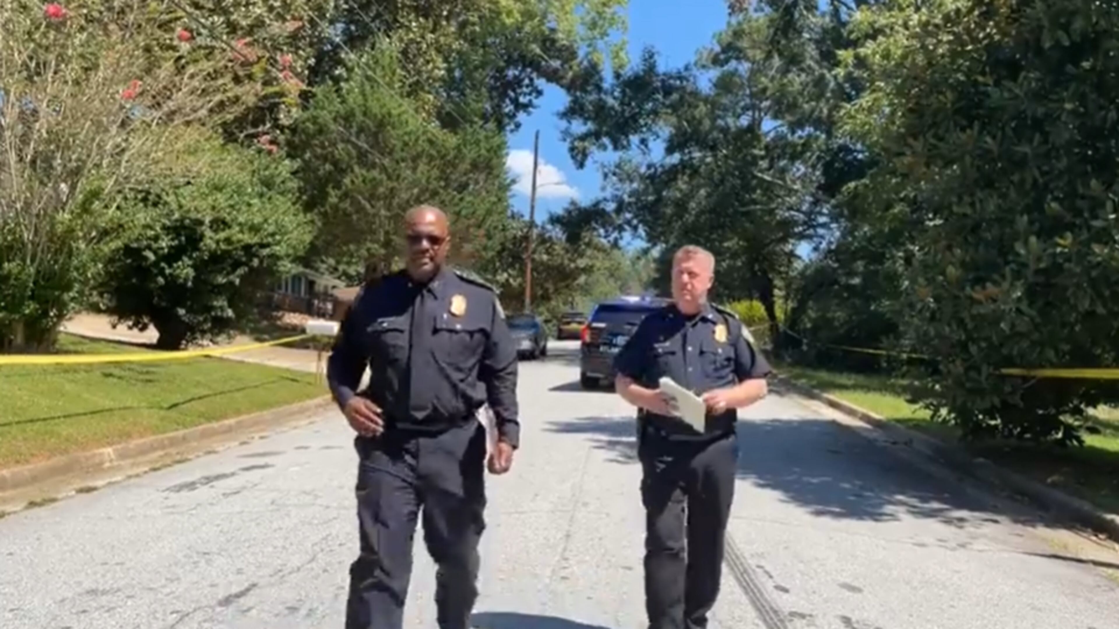 Atlanta police Deputy Chief Charles Hampton (left) and Chief Darin Schierbaum speak at the scene of a deadly shooting in northwest Atlanta on Sunday.