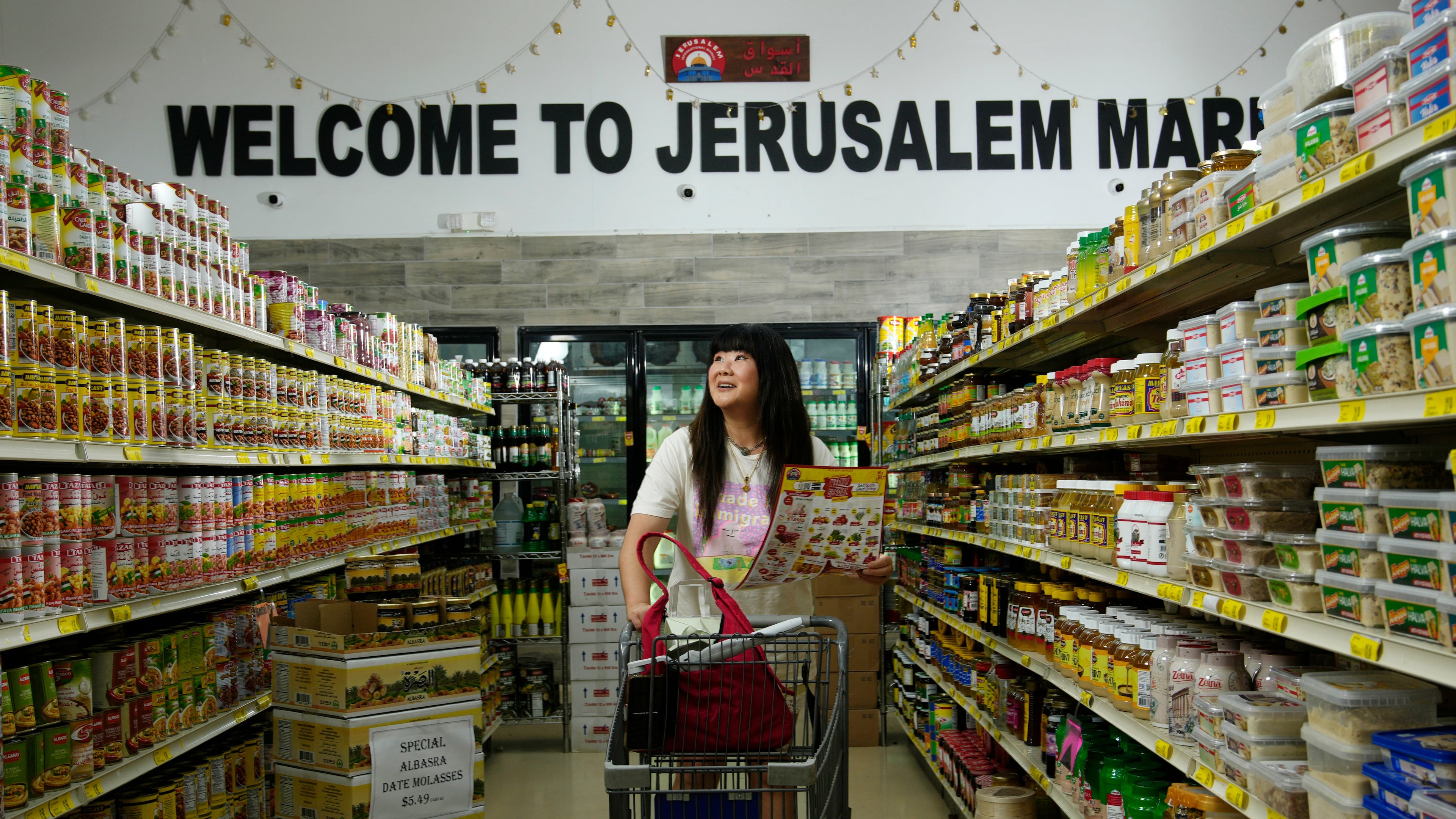 Jenny Yang walks through the Jerusalem Market prior to The Good Egg Immigrant Grocery Store Stand Up Comedy Tour show, July 31, 2026, in Phoenix. (AP Photo/Ross D. Franklin)