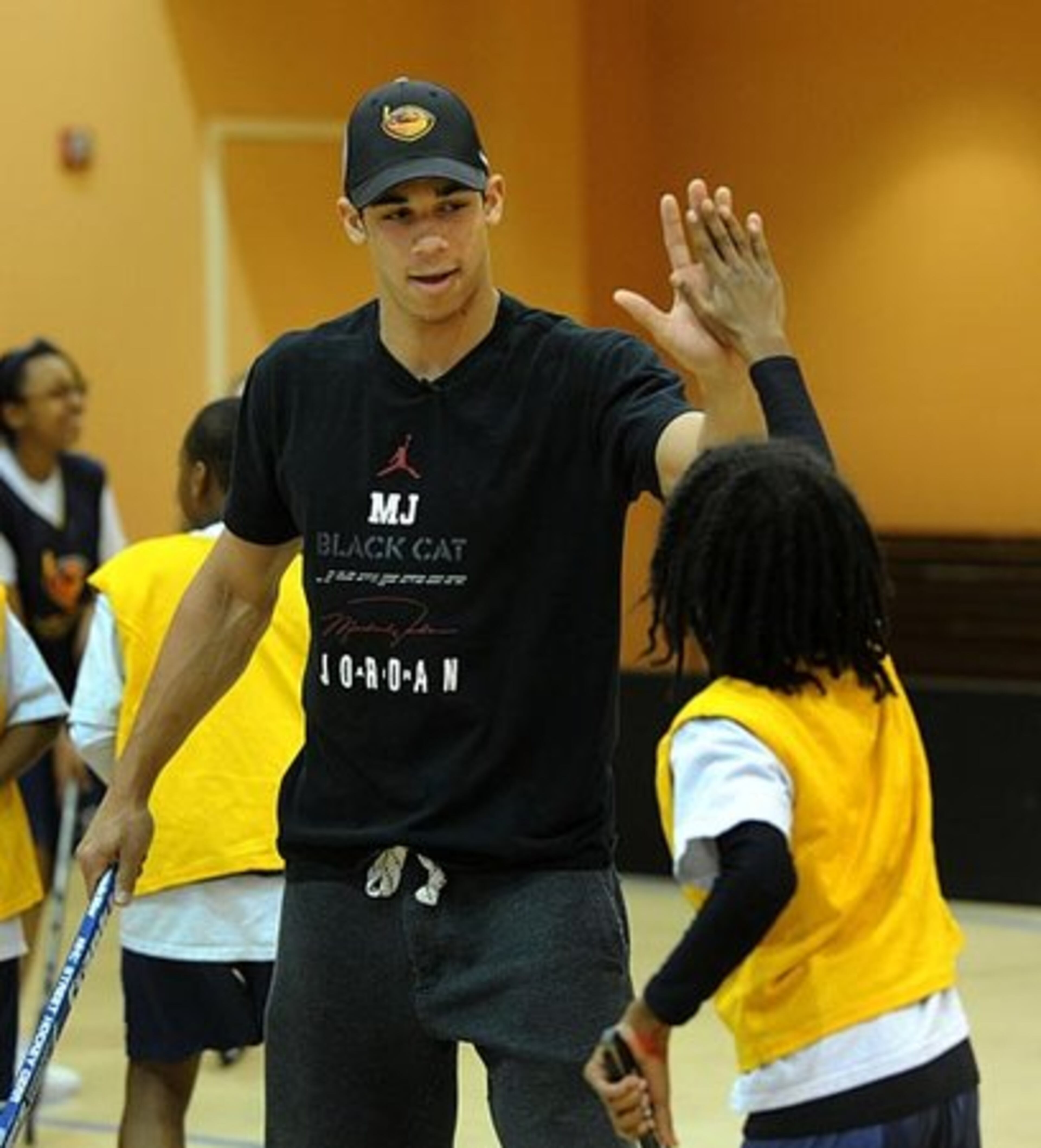 Thrashers forward Evander Kane gives Garnett Simpson a high five after Simpson scored a goal.