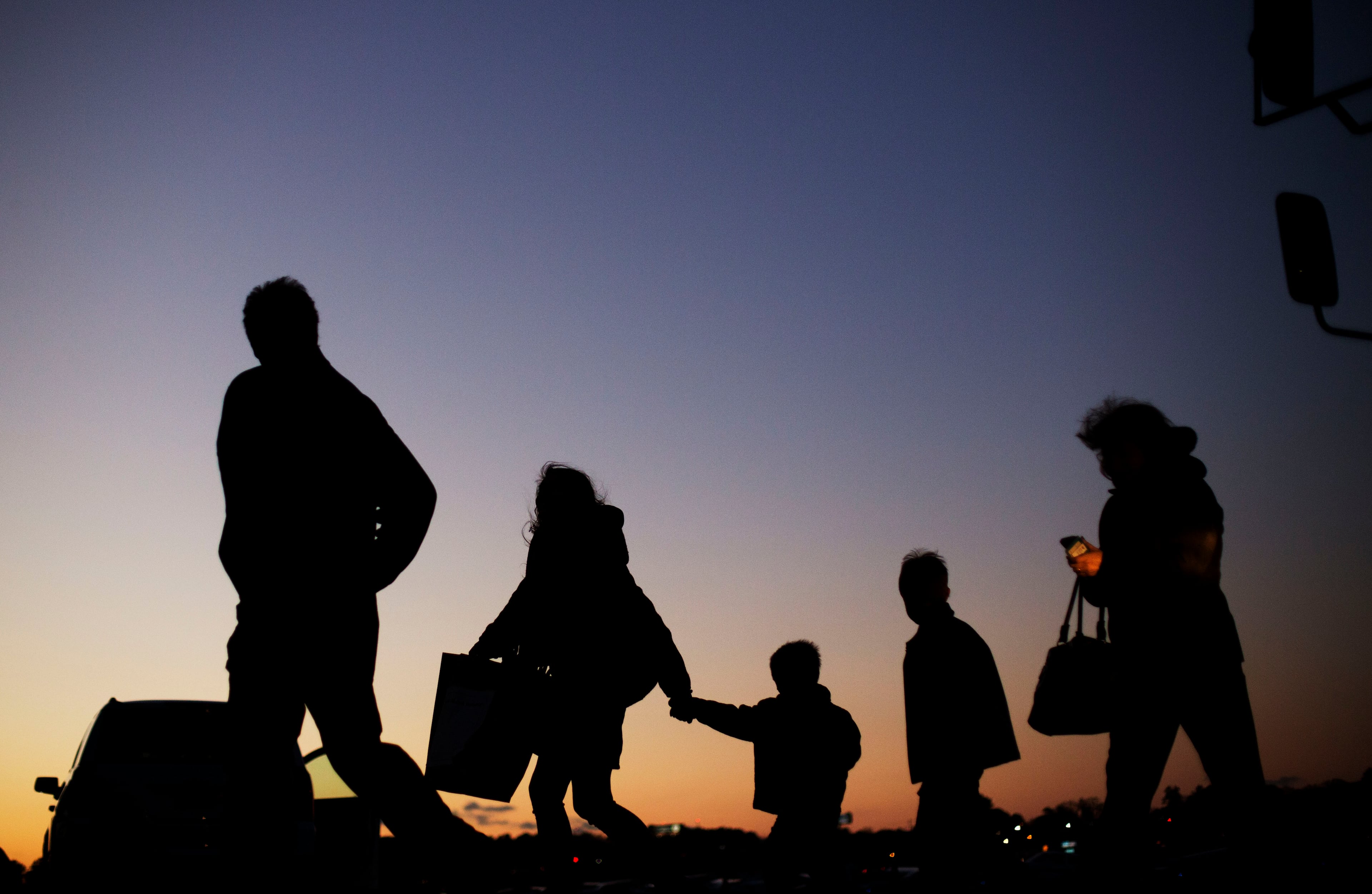 Members of the public cross a tarmac after getting off a bus as they arrive for a campaign event at an airport hanger for Republican presidential candidate, Sen. Ted Cruz, R-Texas, Friday, Dec. 18, 2015, in Kennesaw, Ga. (AP Photo/David Goldman)