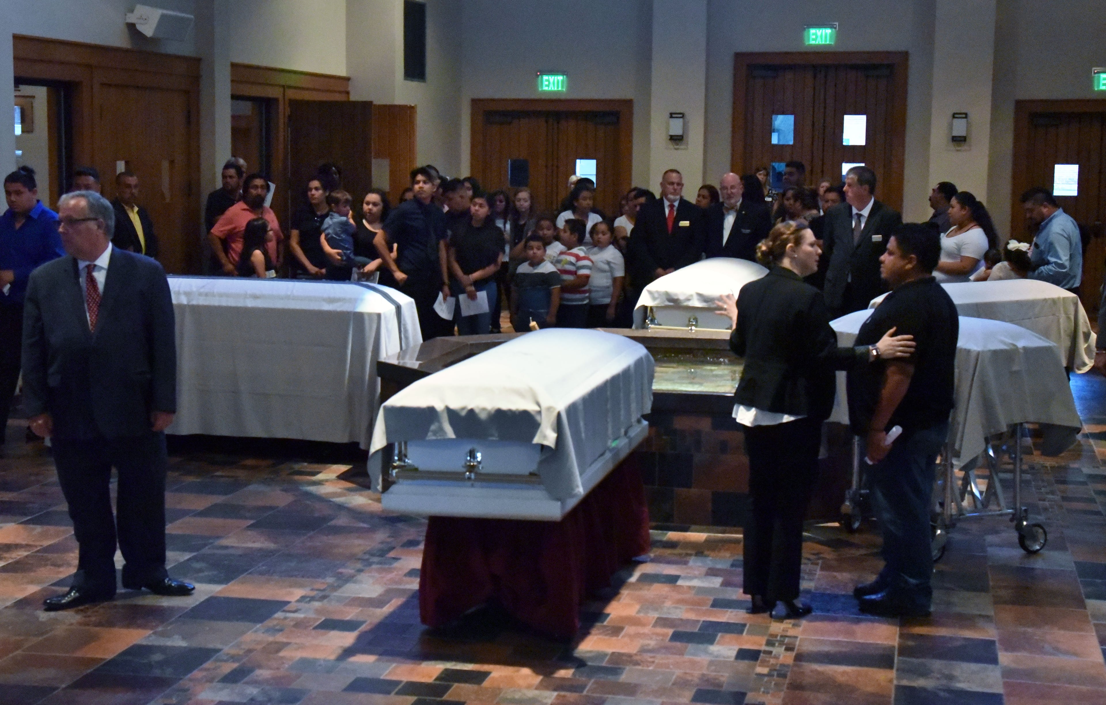 July 13, 2017 Lawrenceville - Fives caskets of the victims - Martin Romero, 33, and four of his children -are surrounded by mourners before the funeral mass for at St. Lawrence Catholic Church in Lawrenceville on Thursday, July 13, 2017. Thirty-three-year-old Martin Romero and children Axel, 1, Dillan, 4, Dacota, 6 and Isabela Martinez, 10, were stabbed to death last week in their Loganville home. Nine-year-old daughter Diana Romero survived the attack and is recovering from her wounds at Children's Healthcare of Atlanta. HYOSUB SHIN / HSHIN@AJC.COM