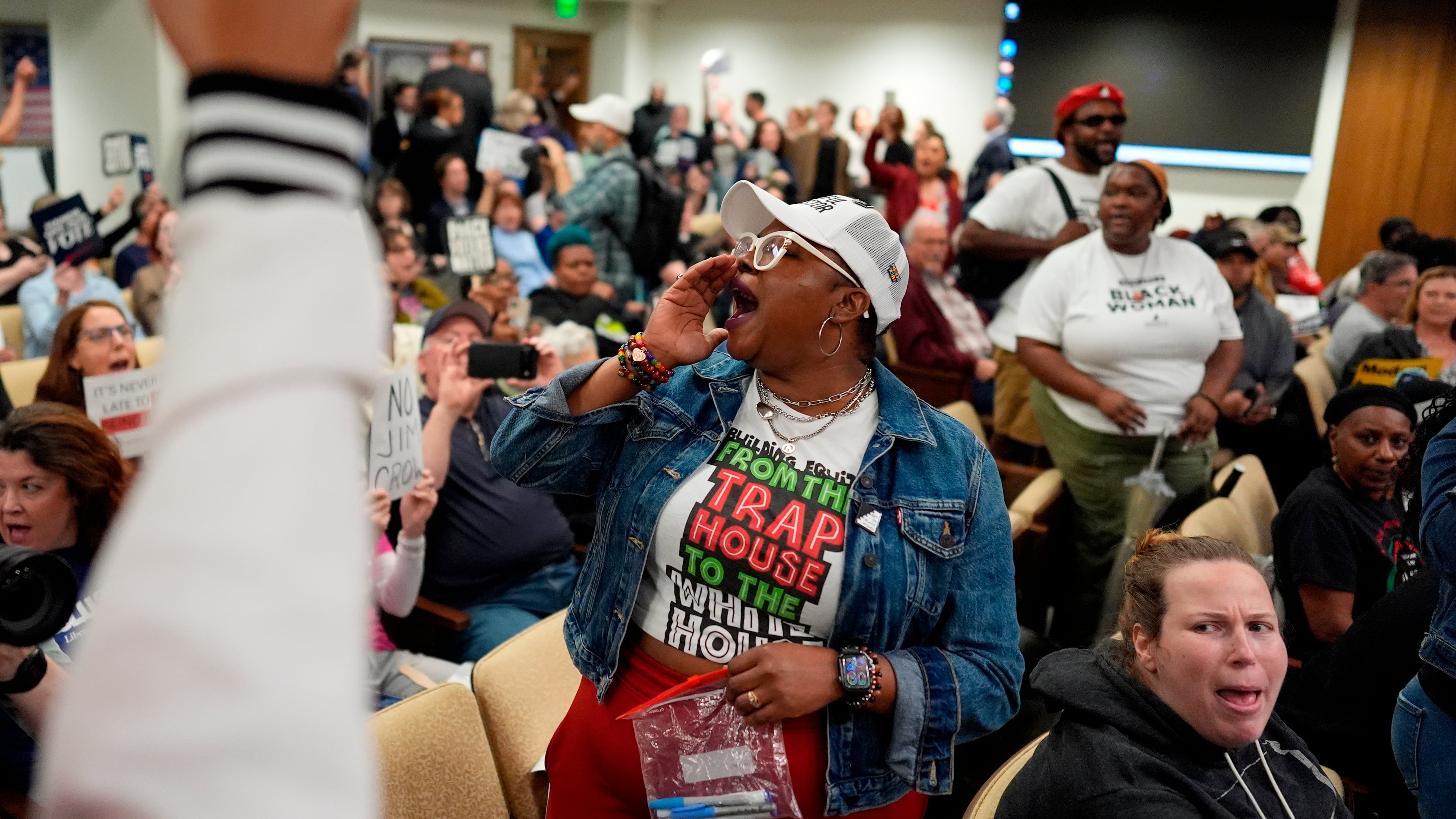 People protest in a Senate committee meeting during a special session of the state legislature to redraw U.S. Congressional voting maps Wednesday, May 6, 2026, in Nashville, Tenn. (AP Photo/George Walker IV)
