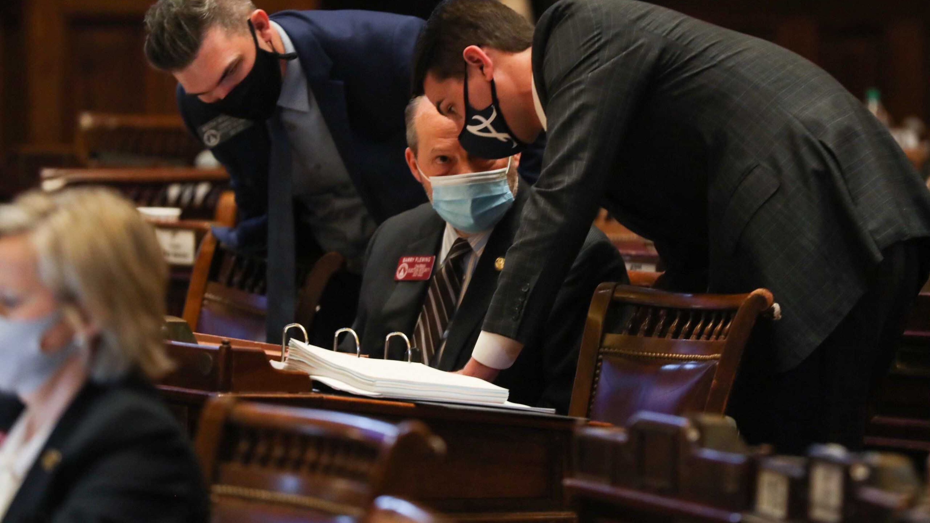 Rep. Trey Kelley, right, speaks with Rep. Barry Fleming, chairman of the Special Committee on Election Integrity, while debate on Senate Bill 202 takes place Thursday in the Georgia House. The measure to overhaul Georgia's election law won passage Thursday in both the House and Senate, and Gov. Brian Kemp signed it into law shortly after that. Alyssa Pointer / alyssa.pointer@ajc.com