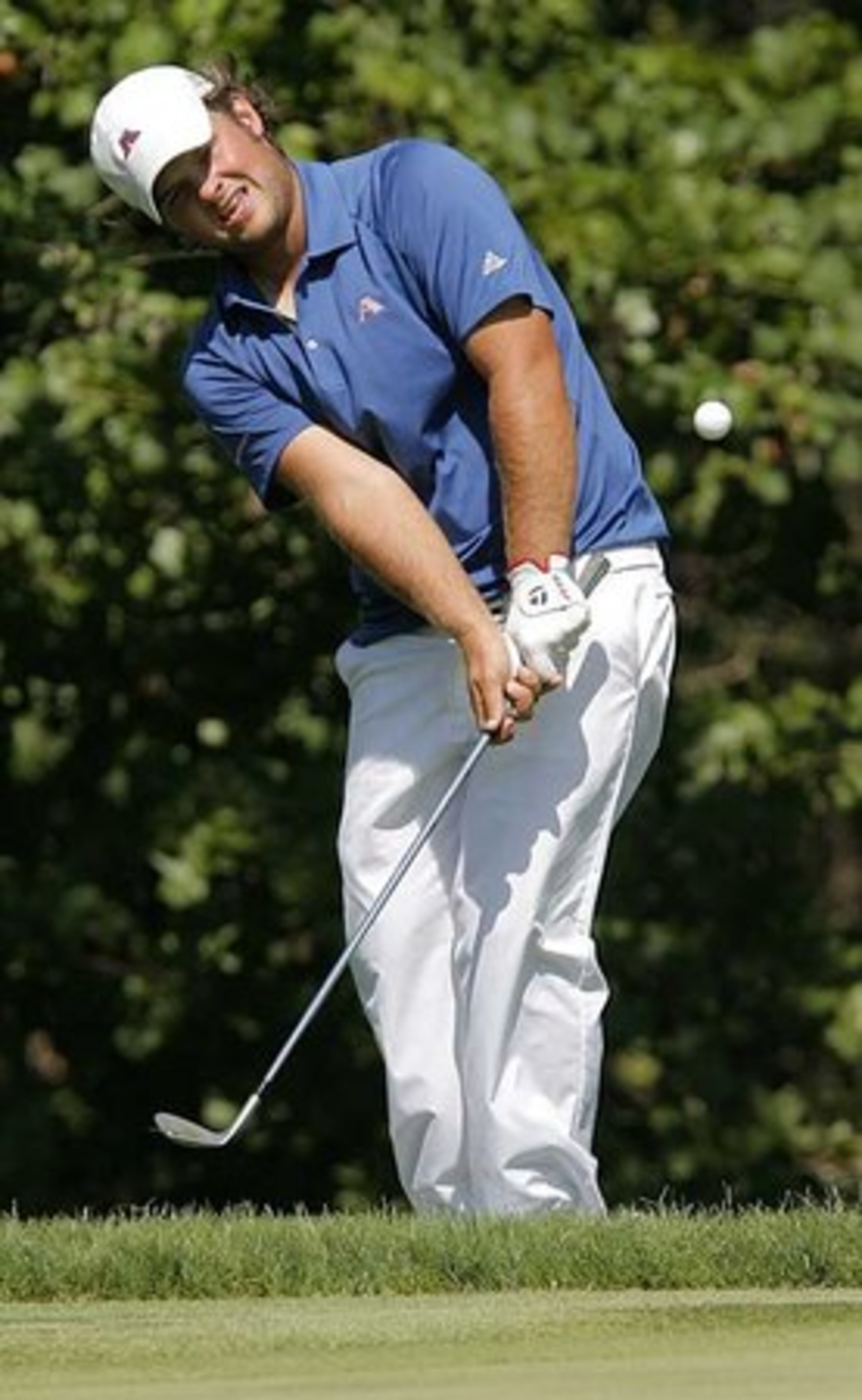 Patrick Reed of Augusta State chips the ball onto the green at No. 14.