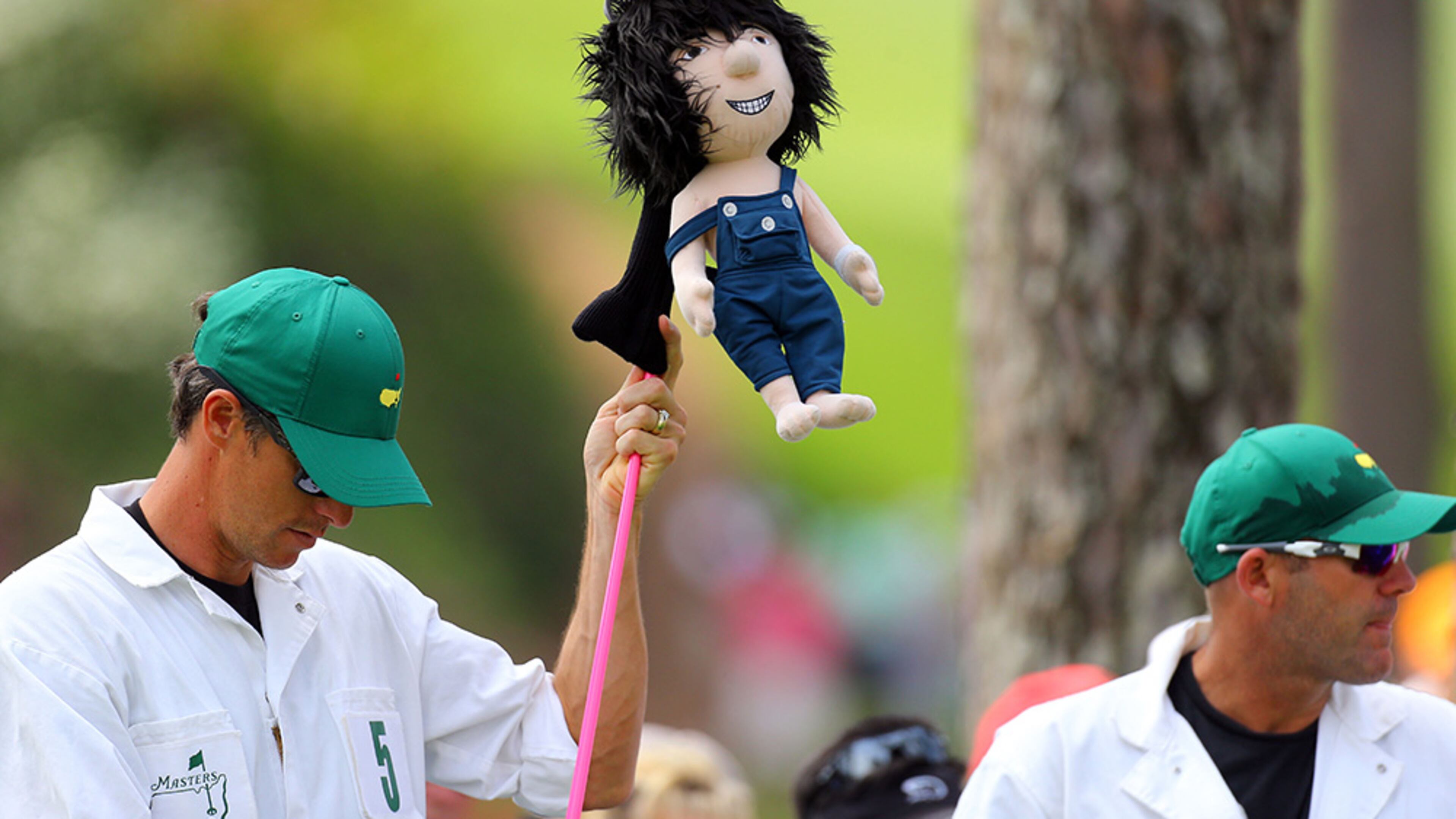 Ted Scott, caddie for two-time Masters champion Bubba Watson, puts cover on driver after teeing off at Augusta National.