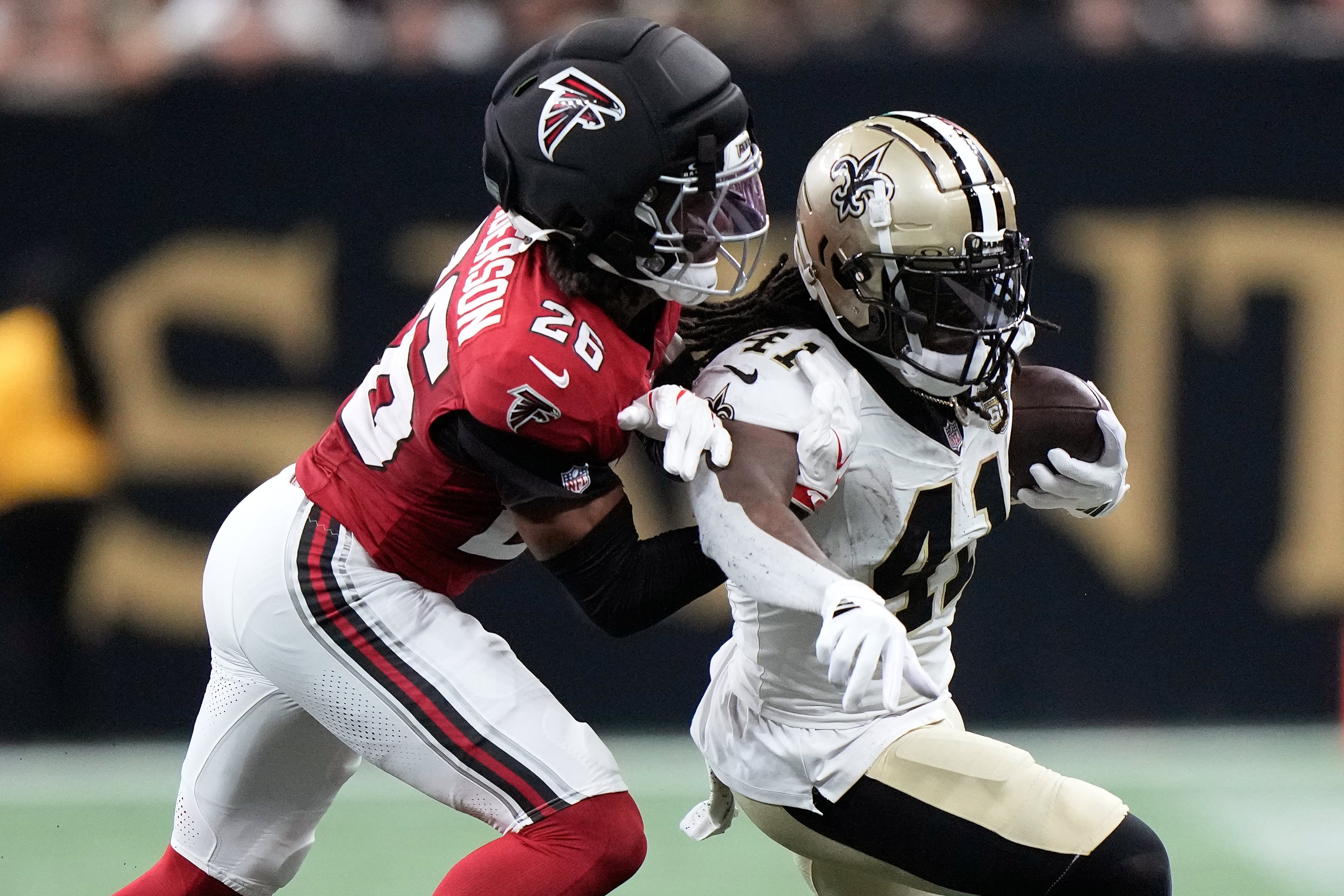 New Orleans Saints running back Alvin Kamara (right) runs against Atlanta Falcons cornerback C.J. Henderson (left) during the second half of an NFL football game in New Orleans, Monday, Oct. 5, 2026. (Gerald Herbert/AP)
