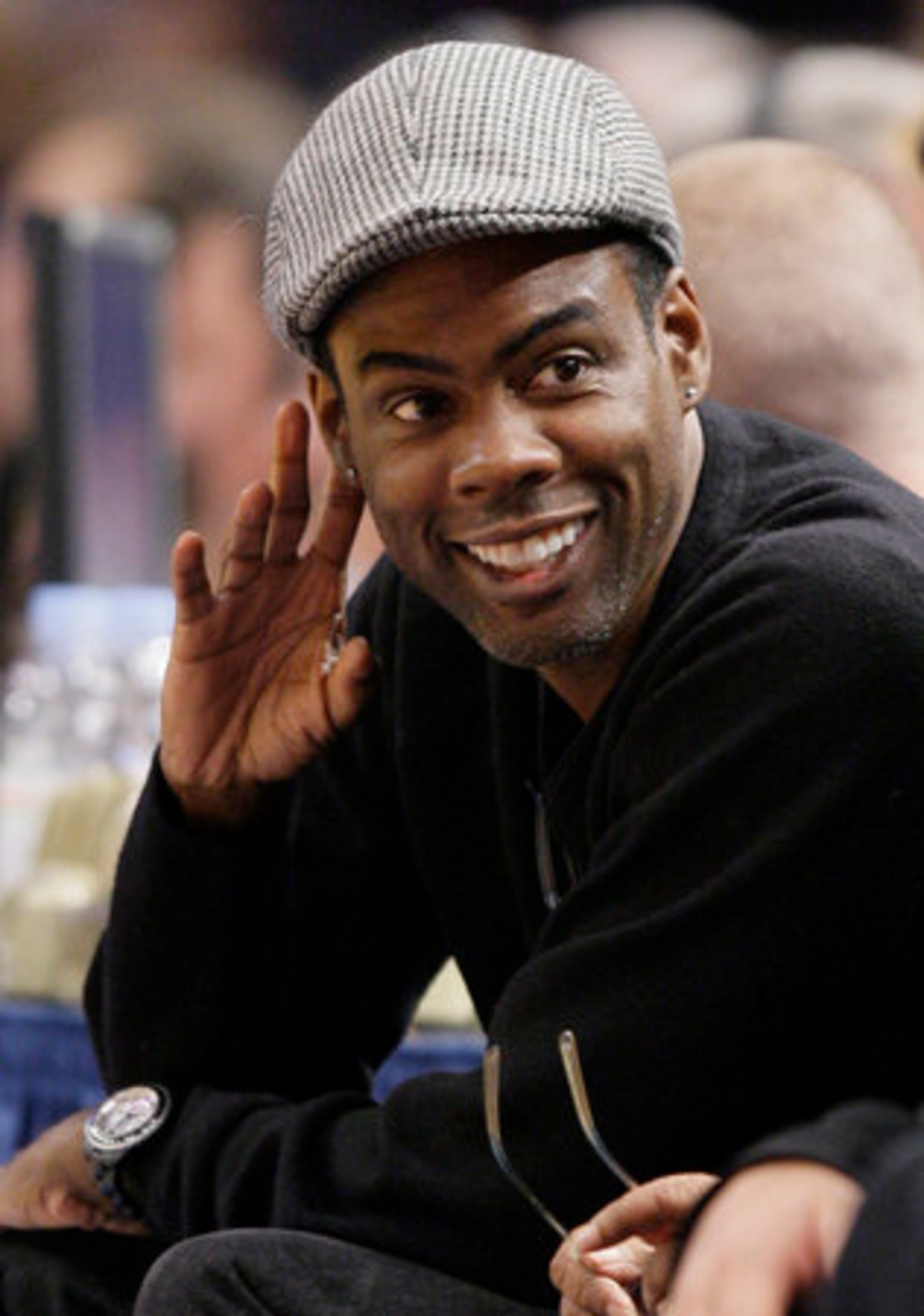 Comedian Chris Rock talks to spectators during a timeout while watching the action between the Indiana Pacers and New York Knicks on Jan. 2 at Madison Square Garden in New York.