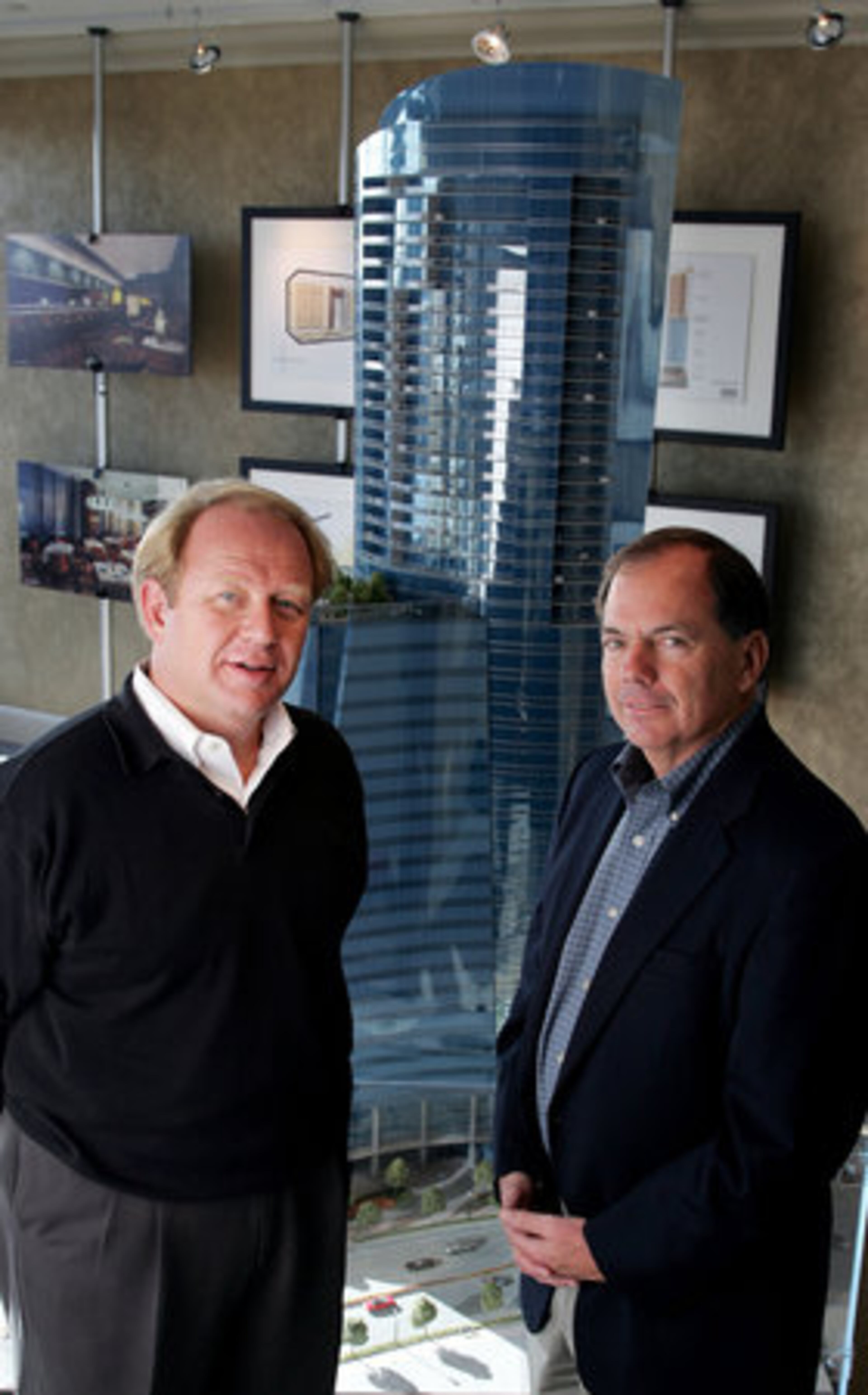 David Tennery (left), principal, and David Allman, chairman of Regent Partners, stand in front of a model of their Sovereign building project in Buckhead.