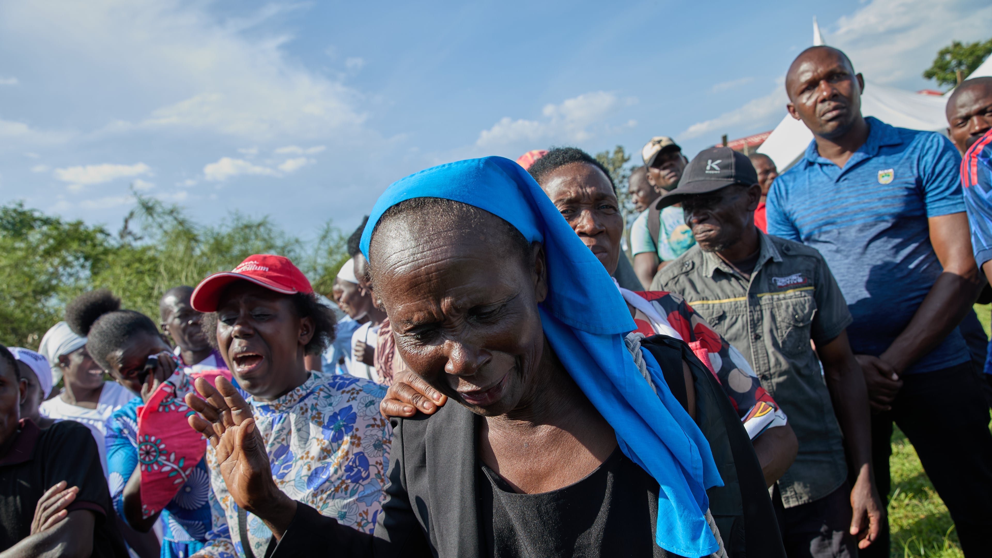 Professional mourners grieve alongside family members and friends of the deceased during a funeral on the outskirts of Kisumu, Kenya, Friday, March 13, 2026. (AP Photo/Asa Wallin)
