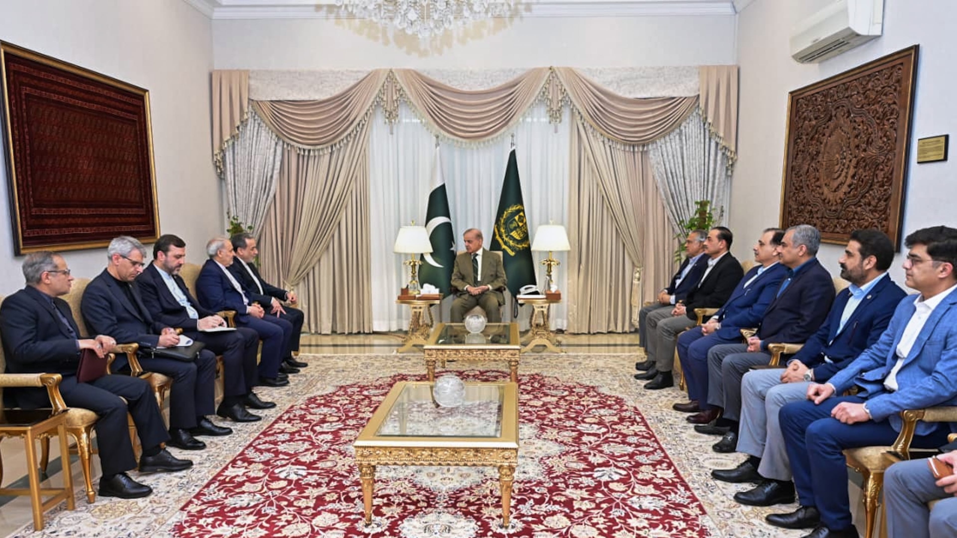 In this photo released by the Pakistan Prime Minister Office, Iran's Foreign Minister Abbas Araghchi, fifth left, meets with Prime Minister Shehbaz Sharif, center, in Islamabad, Pakistan, Saturday, April 25, 2026. (Pakistan Prime Minister Office via AP)