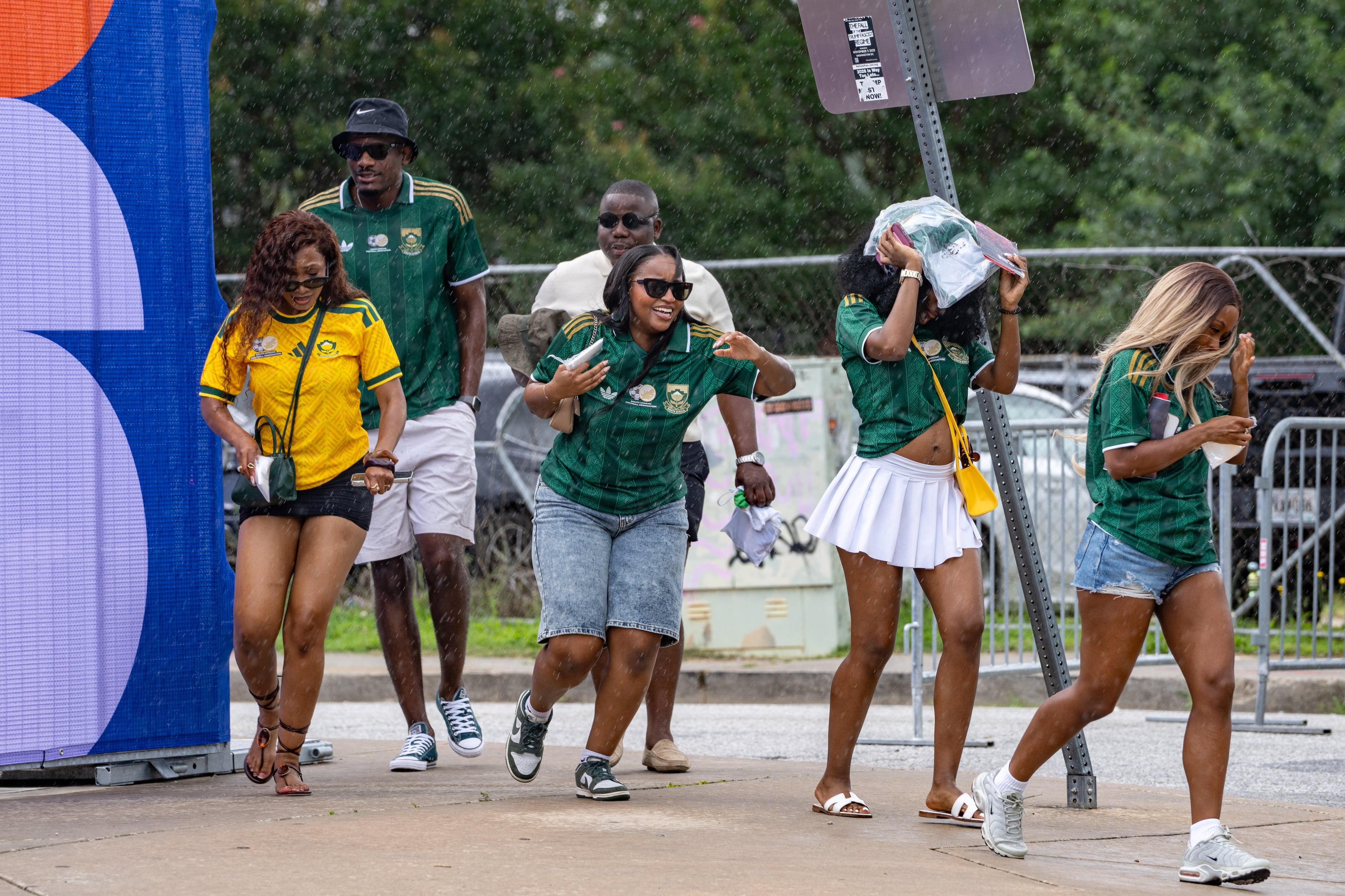 South Africa fans run to Atlanta Stadium in the rain for the South Africa vs. Czechia match on Thursday, June 18, 2026. (Ben Hendren for the AJC)