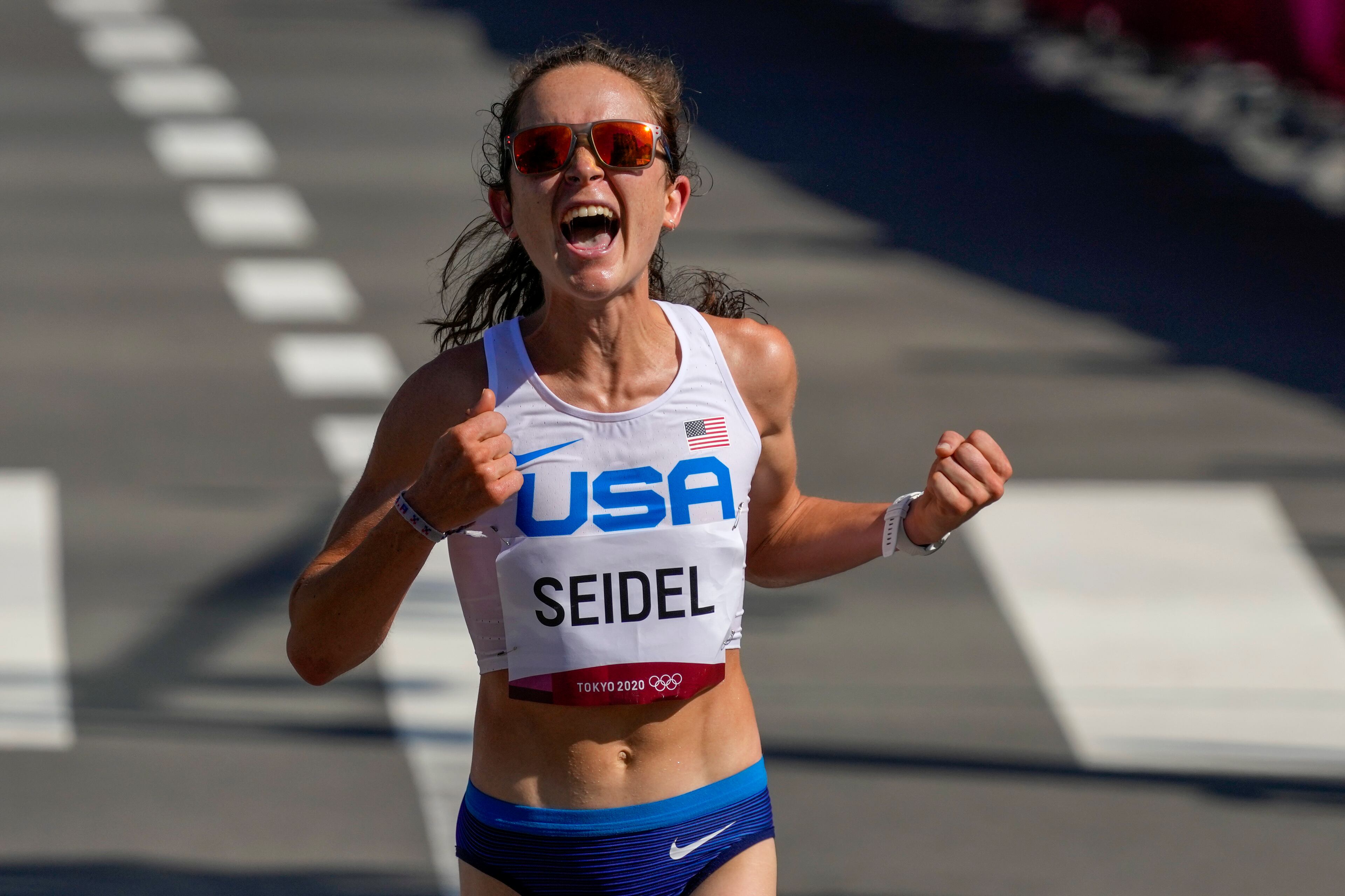 Molly Seidel, of the United States, celebrates as she crosses the finish line to win the bronze medal in the women's marathon at the 2020 Summer Olympics, Saturday, Aug. 7, 2021, in Sapporo, Japan. The American was the women’s winner in the 2020 virtual Atlanta Journal-Constitution Peachtree Road Race. (AP Photo/Shuji Kajiyama)