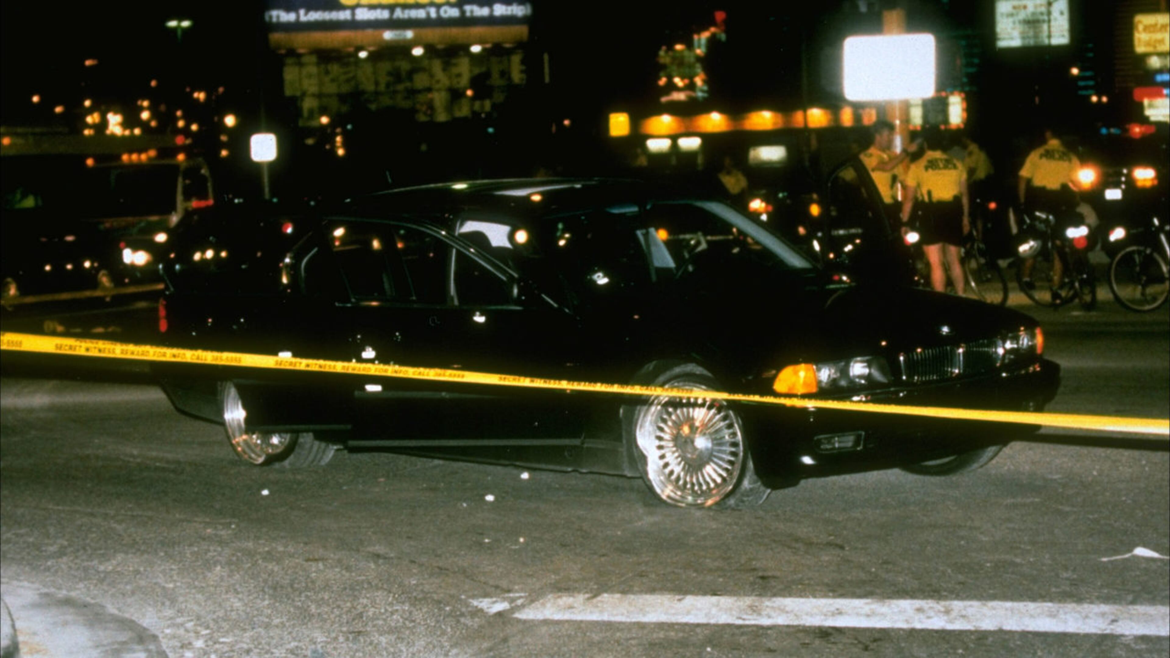 The bullet-riddled BMW in which rapper Tupac Shakur was fatally shot is pictured behind crime scene tape Sept. 7, 1996, at the scene in Las Vegas. Shakur, 25, died six days later, on Sept. 13, from his wounds. His killing has never been solved.