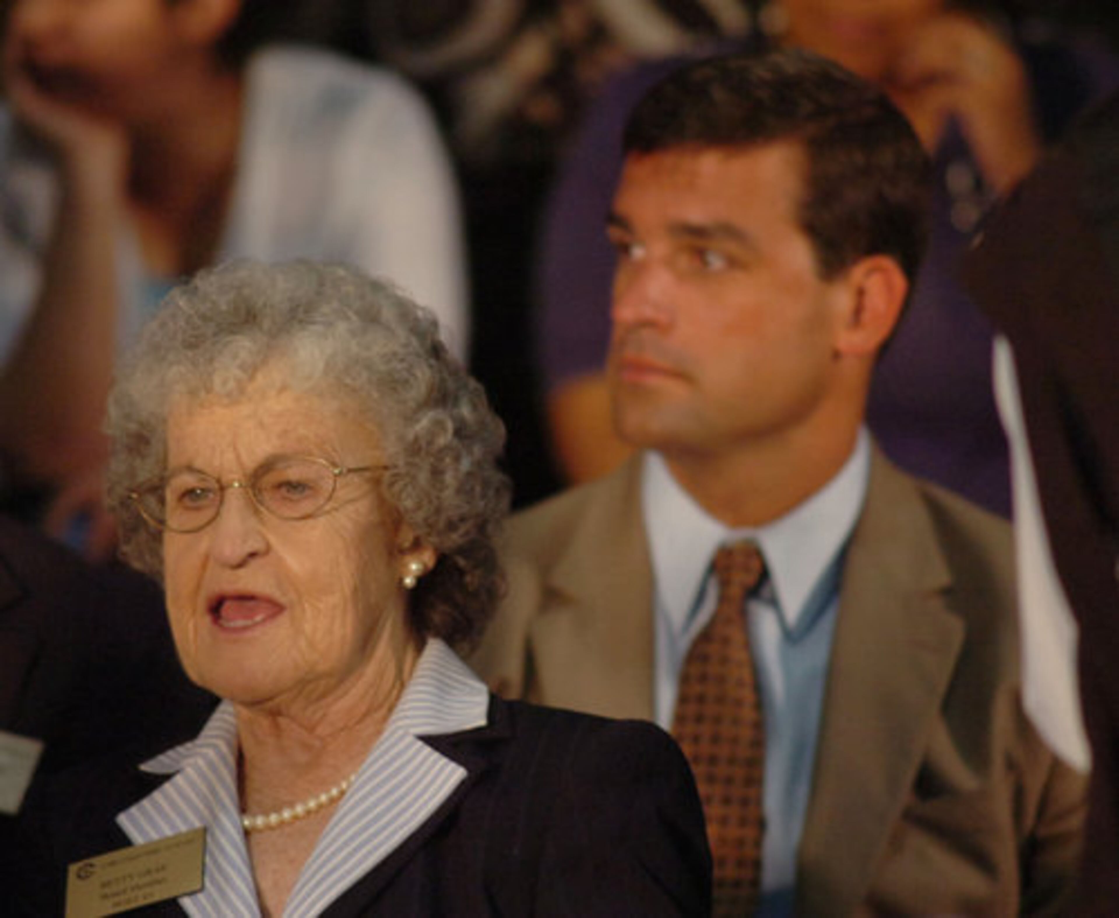 Cobb School Board member Betty Gray (front left) and Grant Rivera, prinicipal of South Cobb High School, wait in the packed gym before Barack Obama's arrival. They joined several others from the Cobb County School system attending the event.