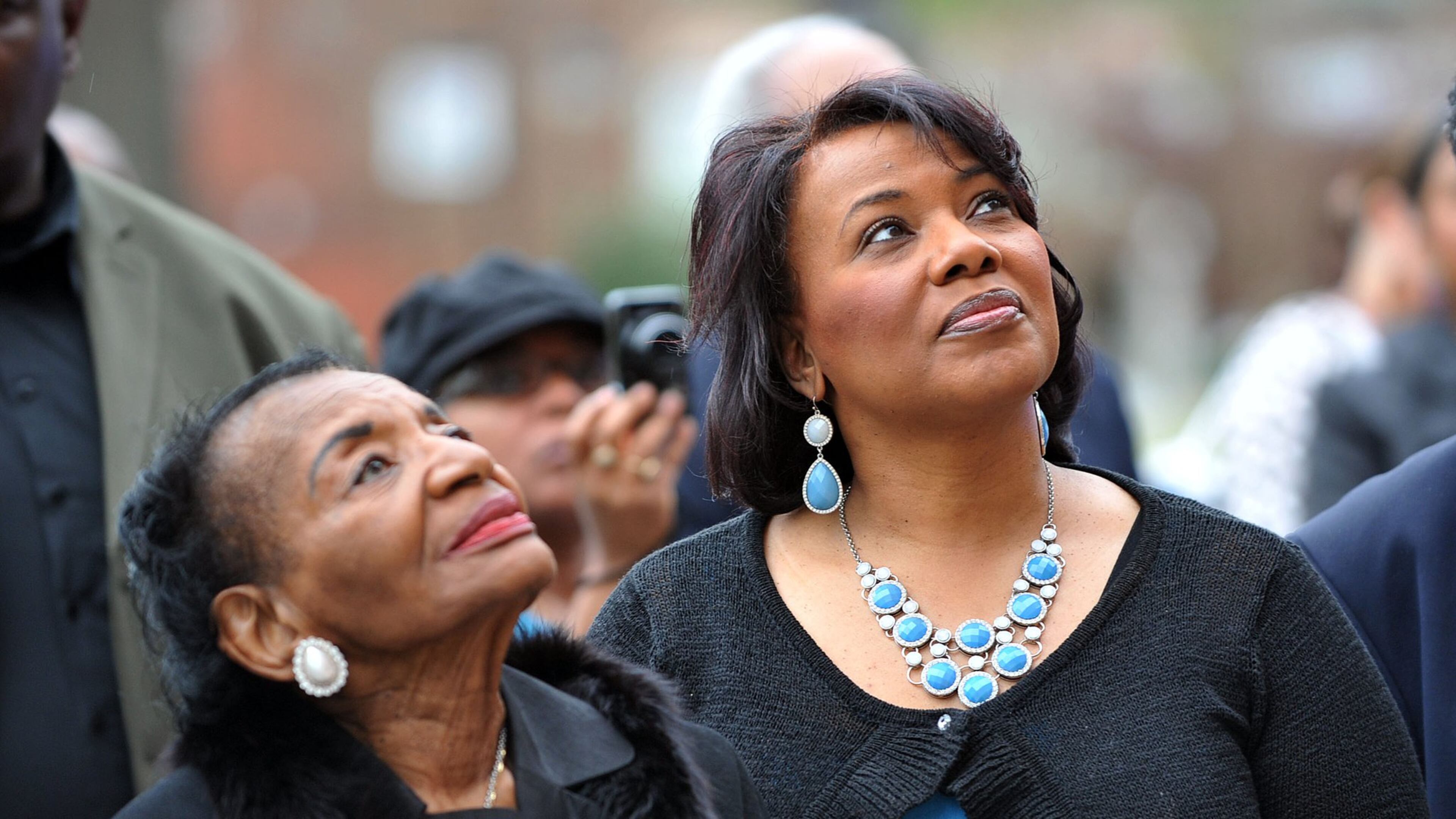 Christine King Farris and her niece, Bernice A. King, watch as a wreath is installed outside Ebenezer Baptist Church in 2014. KENT D. JOHNSON / KDJOHNSON@AJC.COM