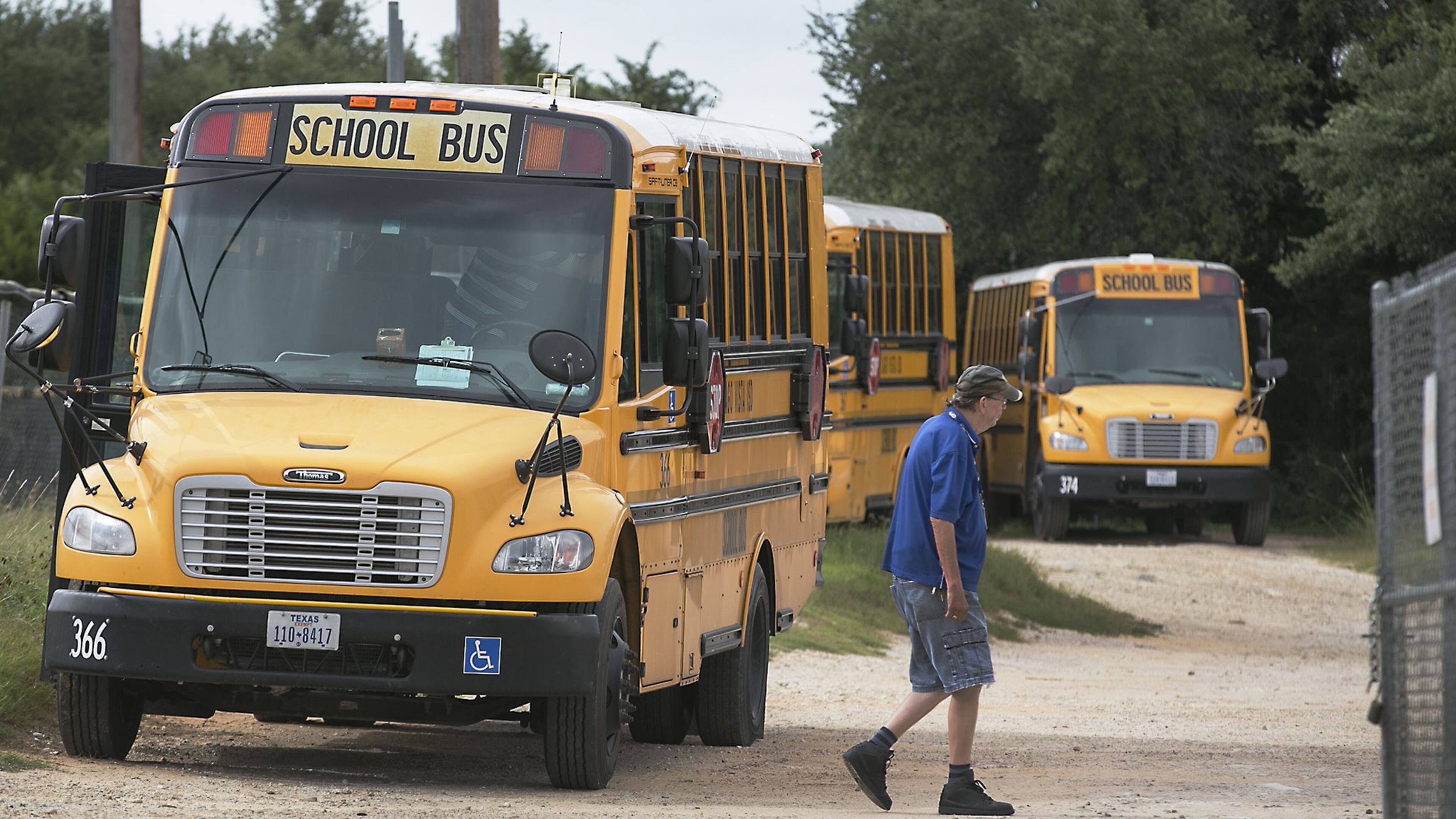The Lago Vista school district’s bus barn is small in comparison to many other other districts’ as a worker walks through the area June 28. About 200 Texas school districts, four of them in Central Texas including Lago Vista, are slated to lose $200 million in state money come Sept. 1, from the Additional State Aid for Tax Reduction program, which was promised to school districts in 2006 to help them maintain the same revenue levels when the Legislature reduced property tax rates by a third.