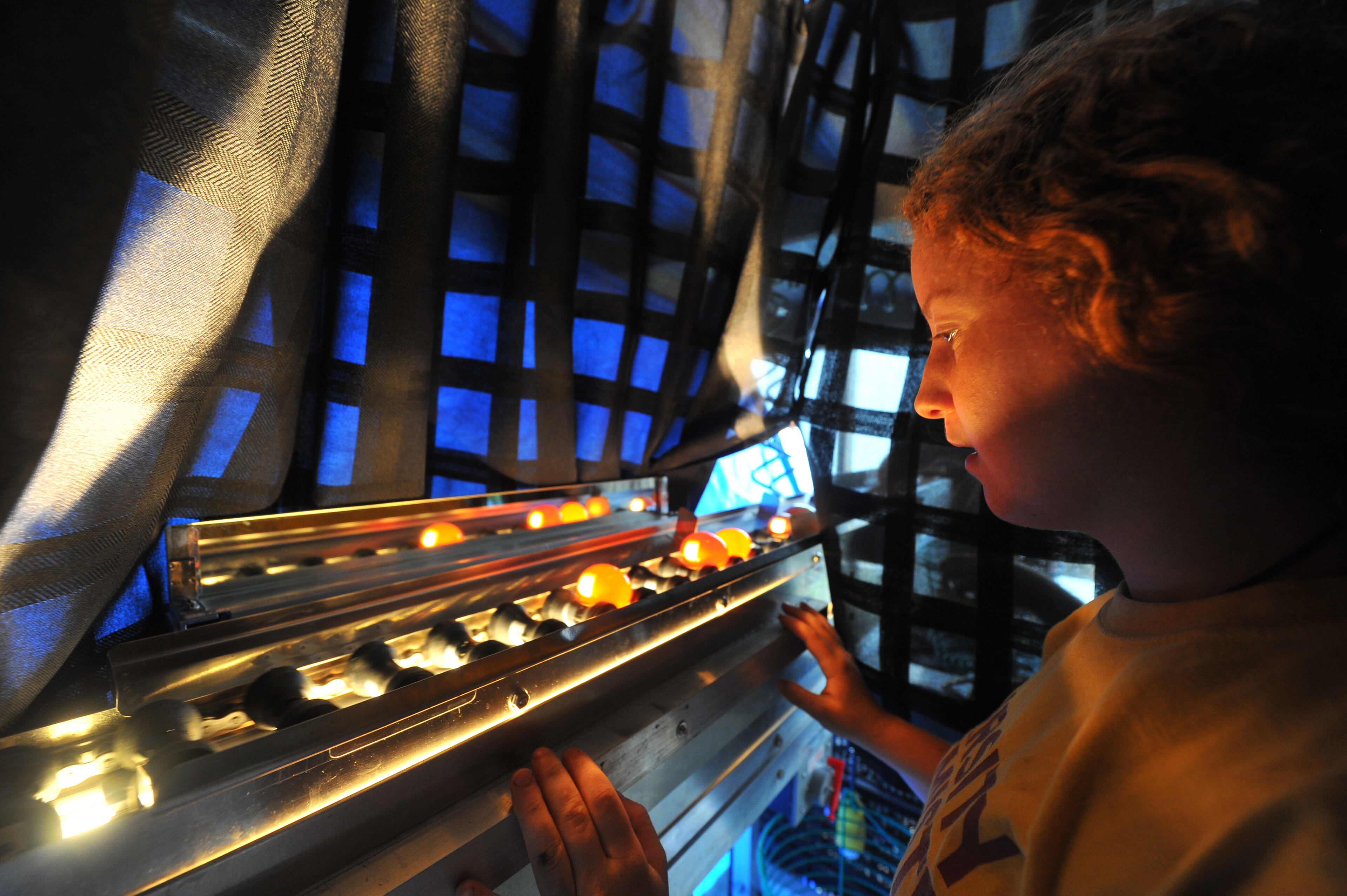 Animal scientist Lori Moshman observes the machine that washes, grades and sorts eggs. The machine's lights allow Moshman to see through the shell to see if any of the eggs have been cracked or fertilized.