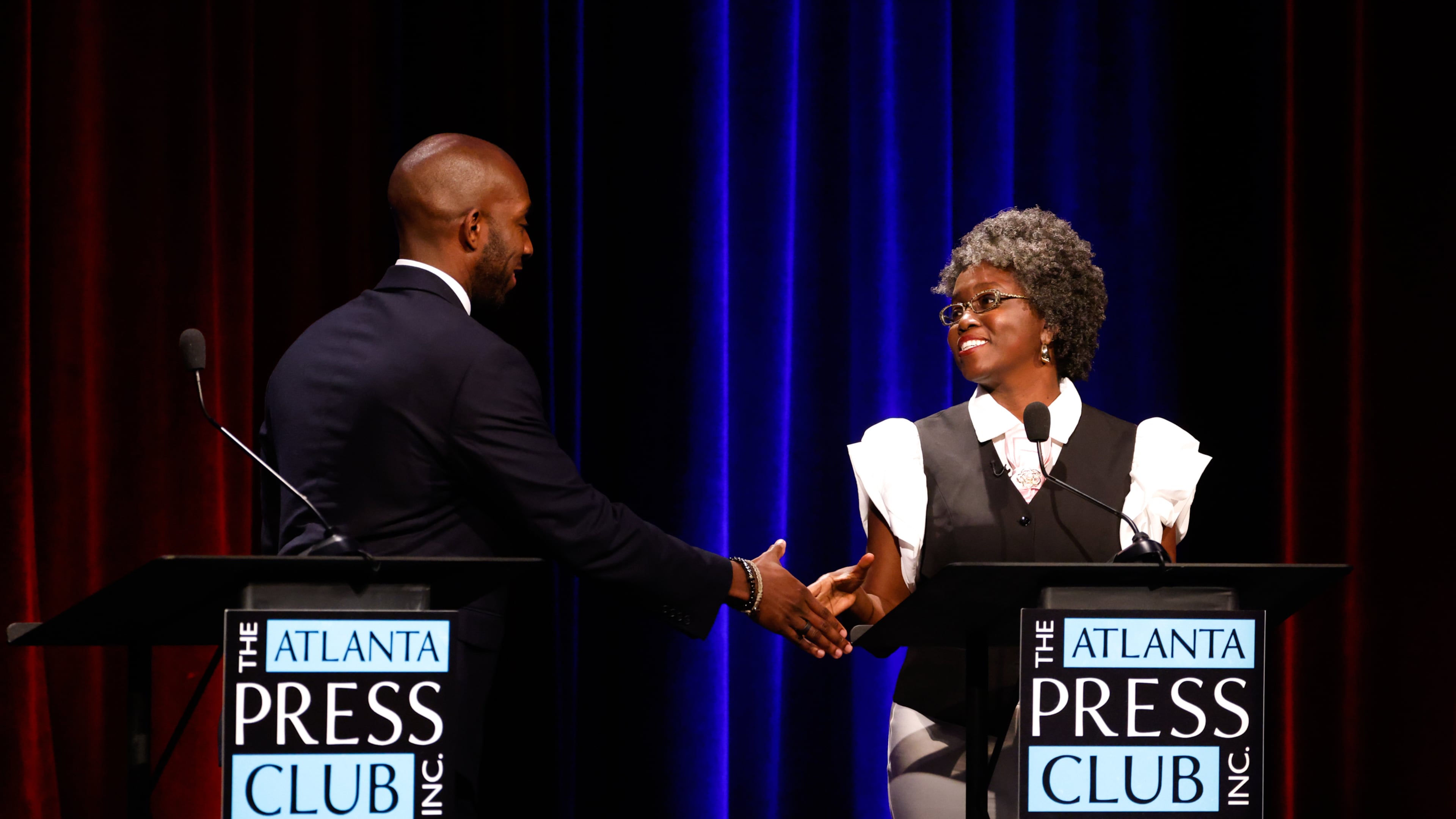 Democratic candidates for Congress, Everton Blair, left, and Jasmine Clark shake hands after the Atlanta Press Club Loudermilk-Young District 13 primary election debate at Georgia Public Broadcasting, Monday, April 27, 2026, in Atlanta. (Arvin Temkar/Atlanta Journal-Constitution via AP)