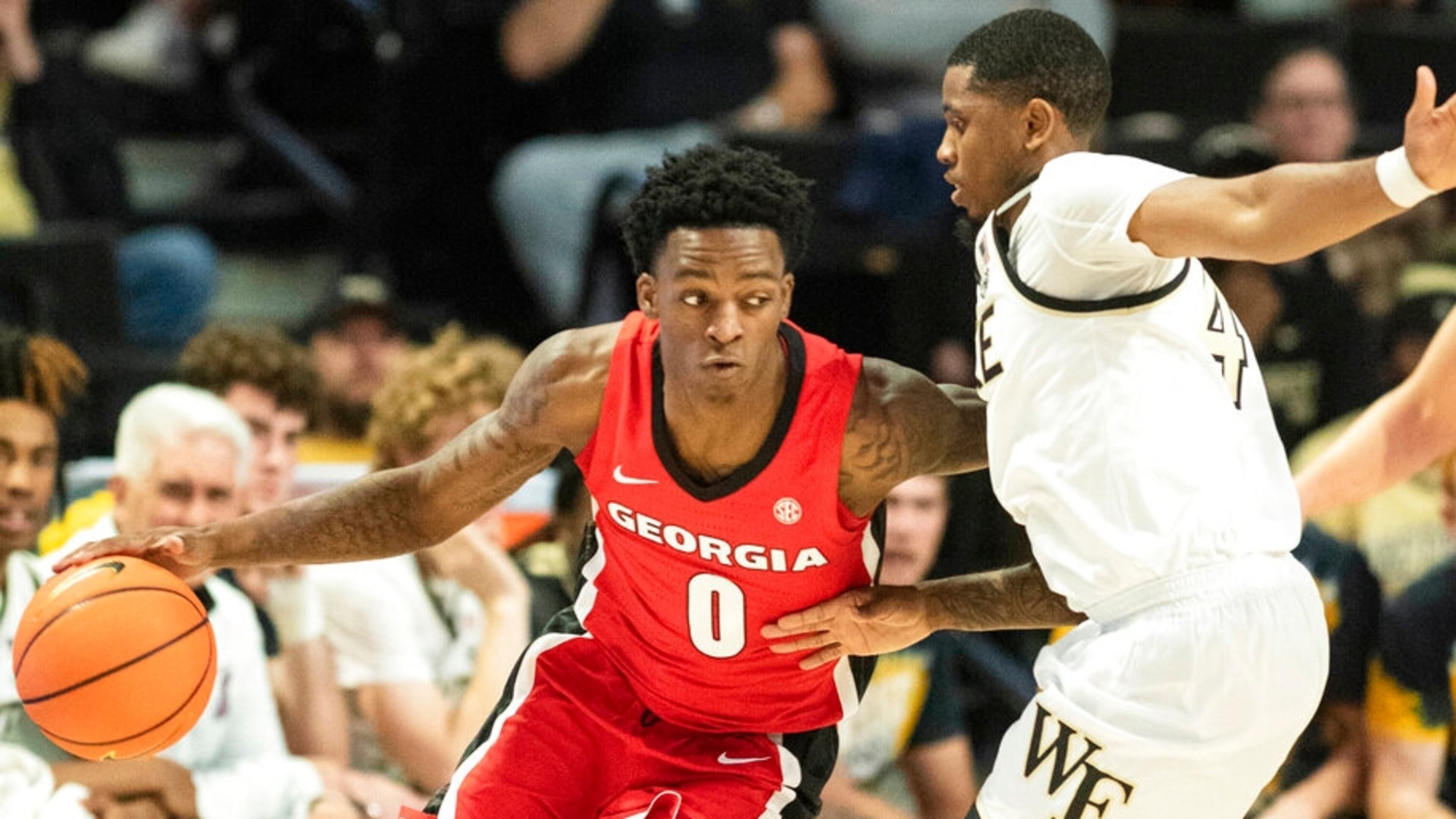 Georgia guard Terry Roberts (0) moves around the defense of Wake Forest guard Daivien Williamson (4) in the first half of an NCAA college basketball game Friday, Nov. 11, 2022, in Winston-Salem, N.C. (Allison Lee Isley/The Winston-Salem Journal via AP)