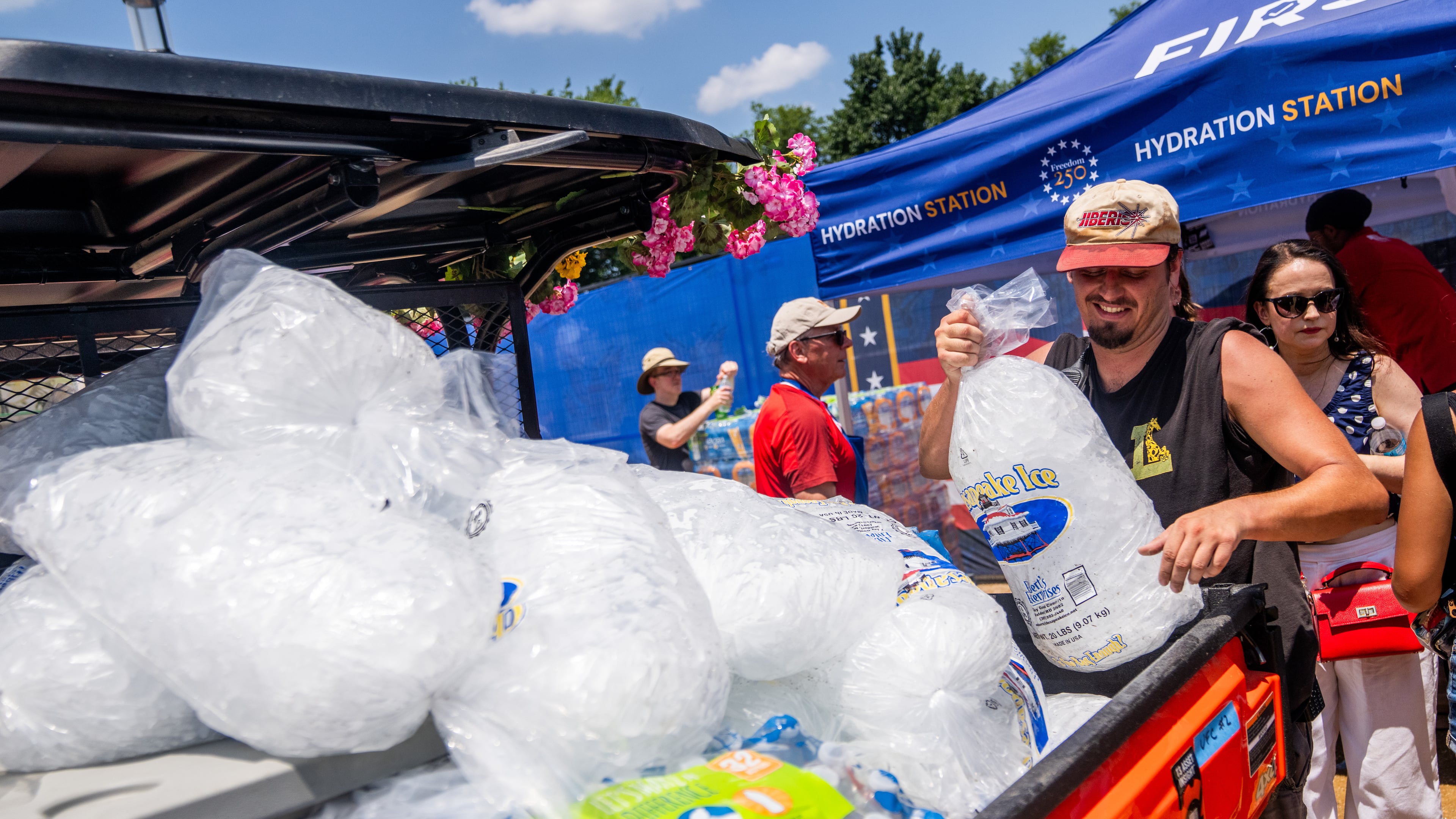 Vendors distribute ice at the Great American State Fair on the National Mall, Friday, July 3, 2026, in Washington. (AP Photo/Allison Robbert)