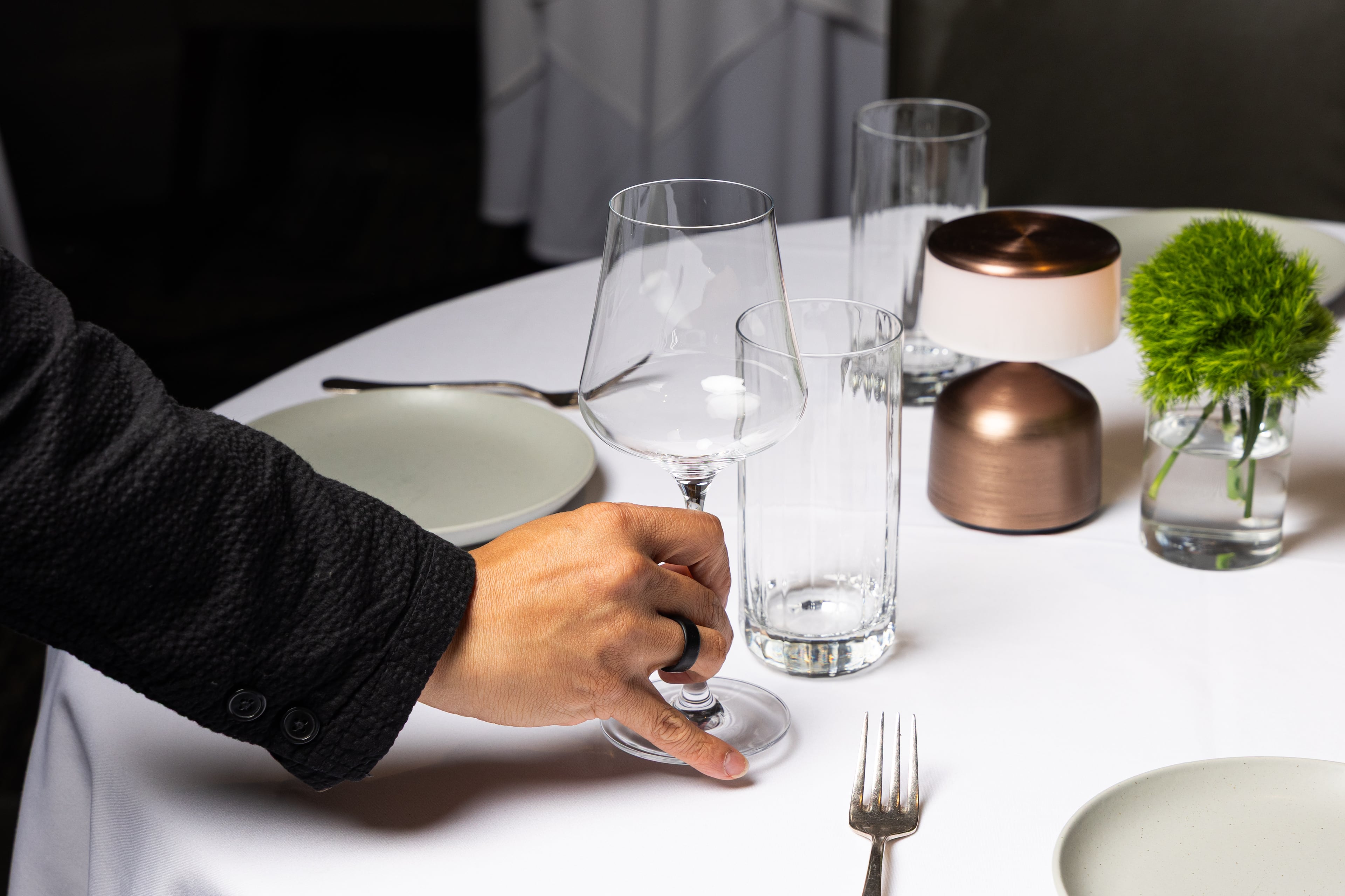 Aria was a James Beard Award nominee for Outstanding Hospitality in both 2025 and 2026. Remy Loet, the restaurant's sommelier, sets out wine glasses on a table before the start of dinner service at Aria on June 5, 2026. (Cameren Rogers for the AJC)