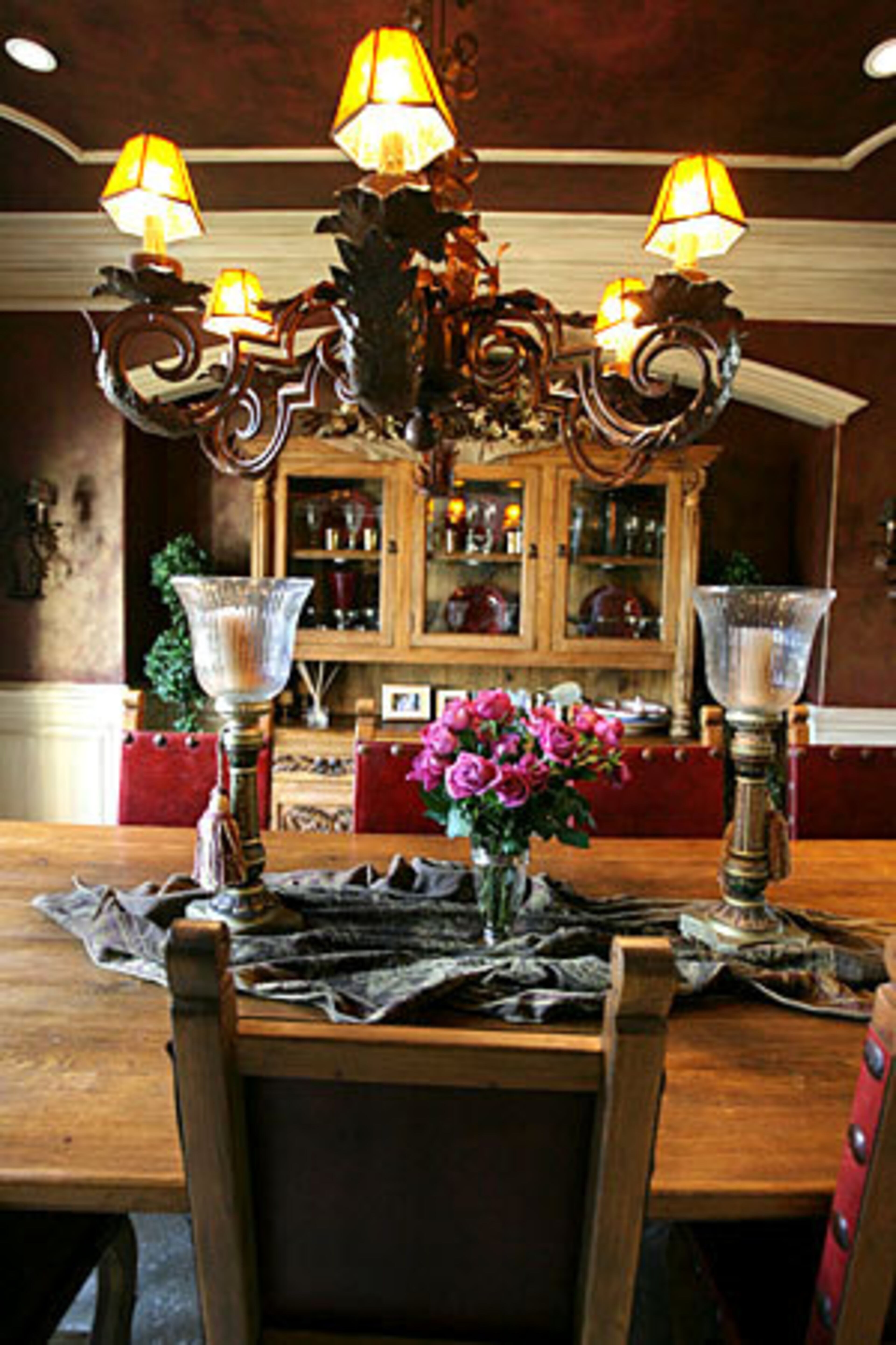 The formal dining room best captures the Old World style with a rich color scheme that includes the ceiling.