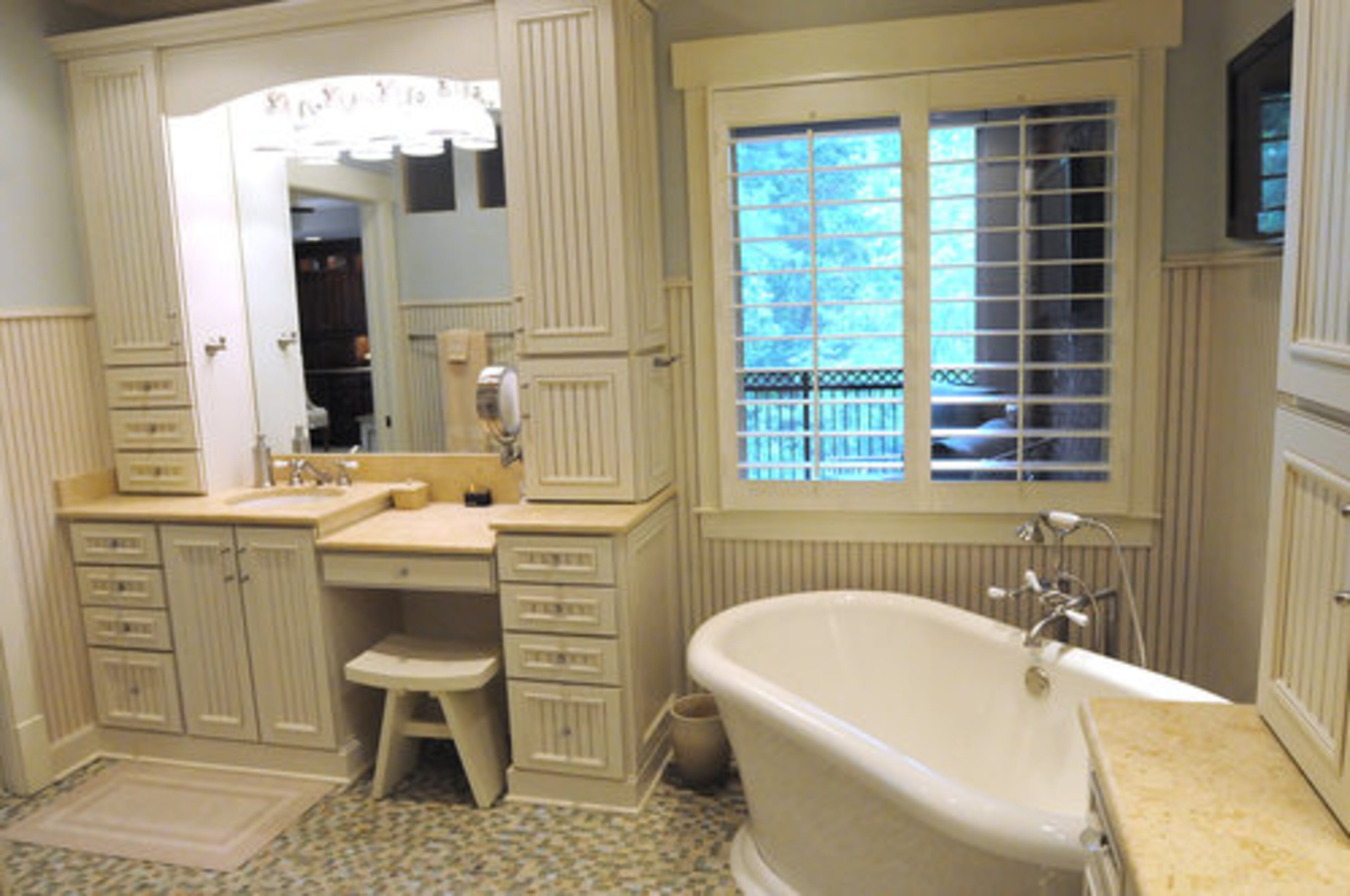 The multicolored tile and a free-floating soaking tub in the master bath help achieve a spalike setting.