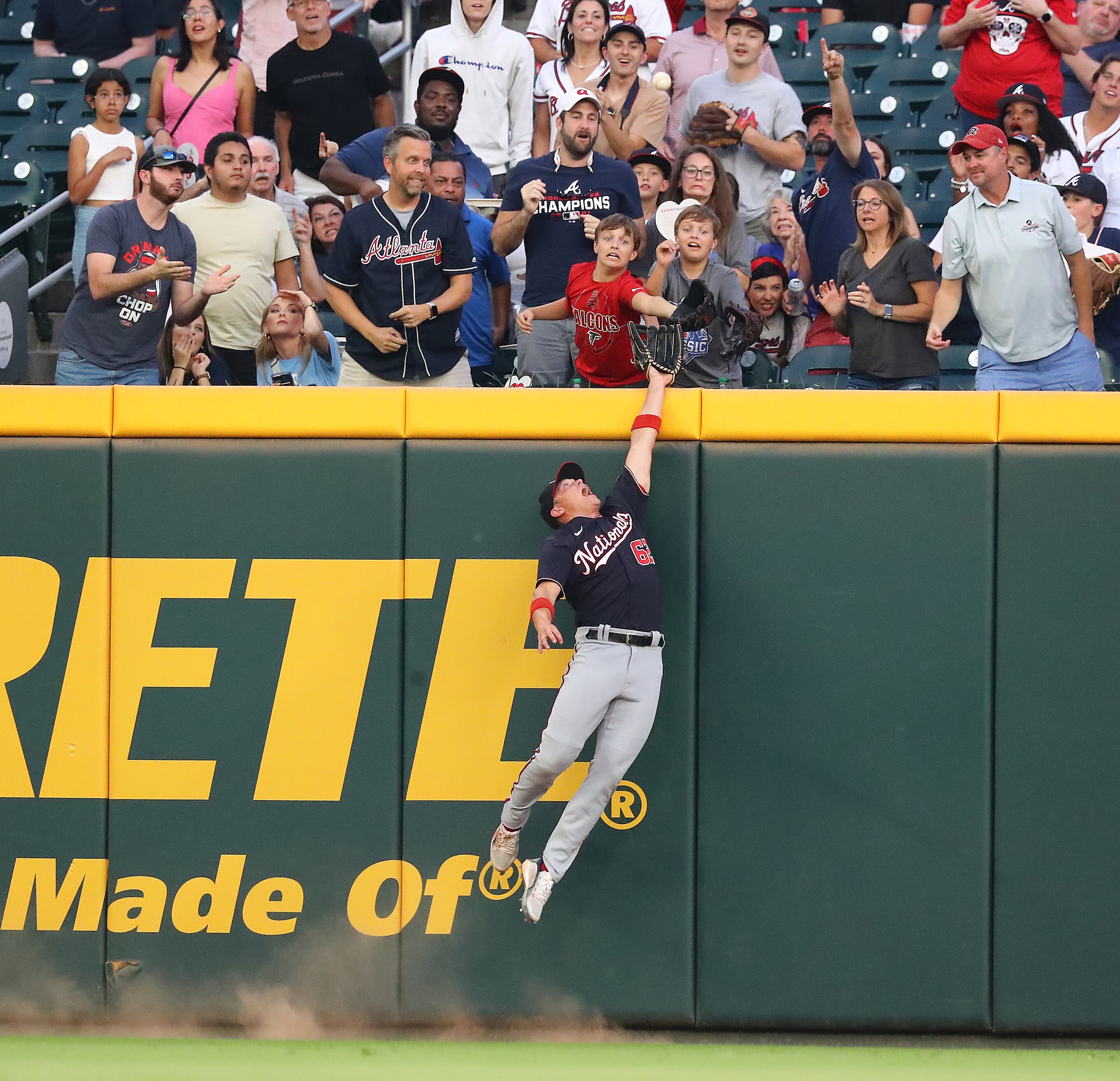 Nationals outfielder Alex Call can't reach a home run by Braves third baseman Austin Riley during the first inning Monday night at Truist Park. (Curtis Compton / Curtis Compton@ajc.com)