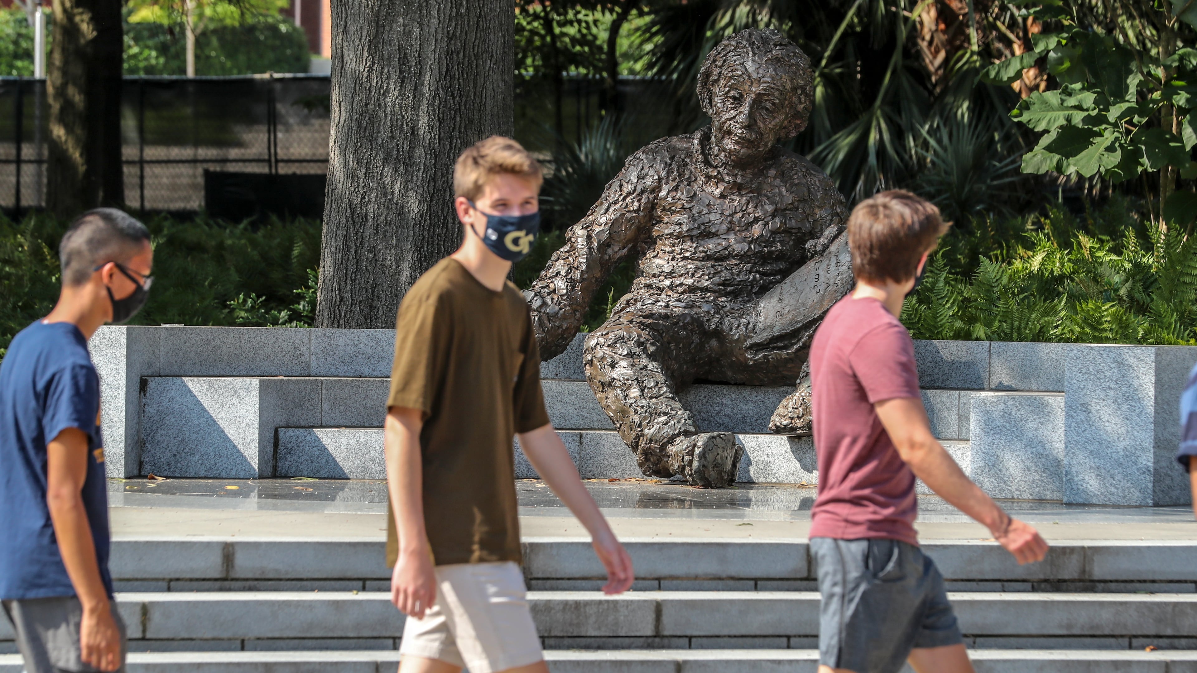 Georgia Tech students masked up and enjoyed a warm day alongside the Albert Einstein monument (who was not wearing a mask) on the Georgia Tech campus on Monday, August 10, 2020. The Albert Einstein Monument on at the northwest corner of Tech Green near the Atlantic Promenade is a 3,500 pound statue that was created by American sculptor Robert Berks (1922-2011). JOHN SPINK/JSPINK@AJC.COM