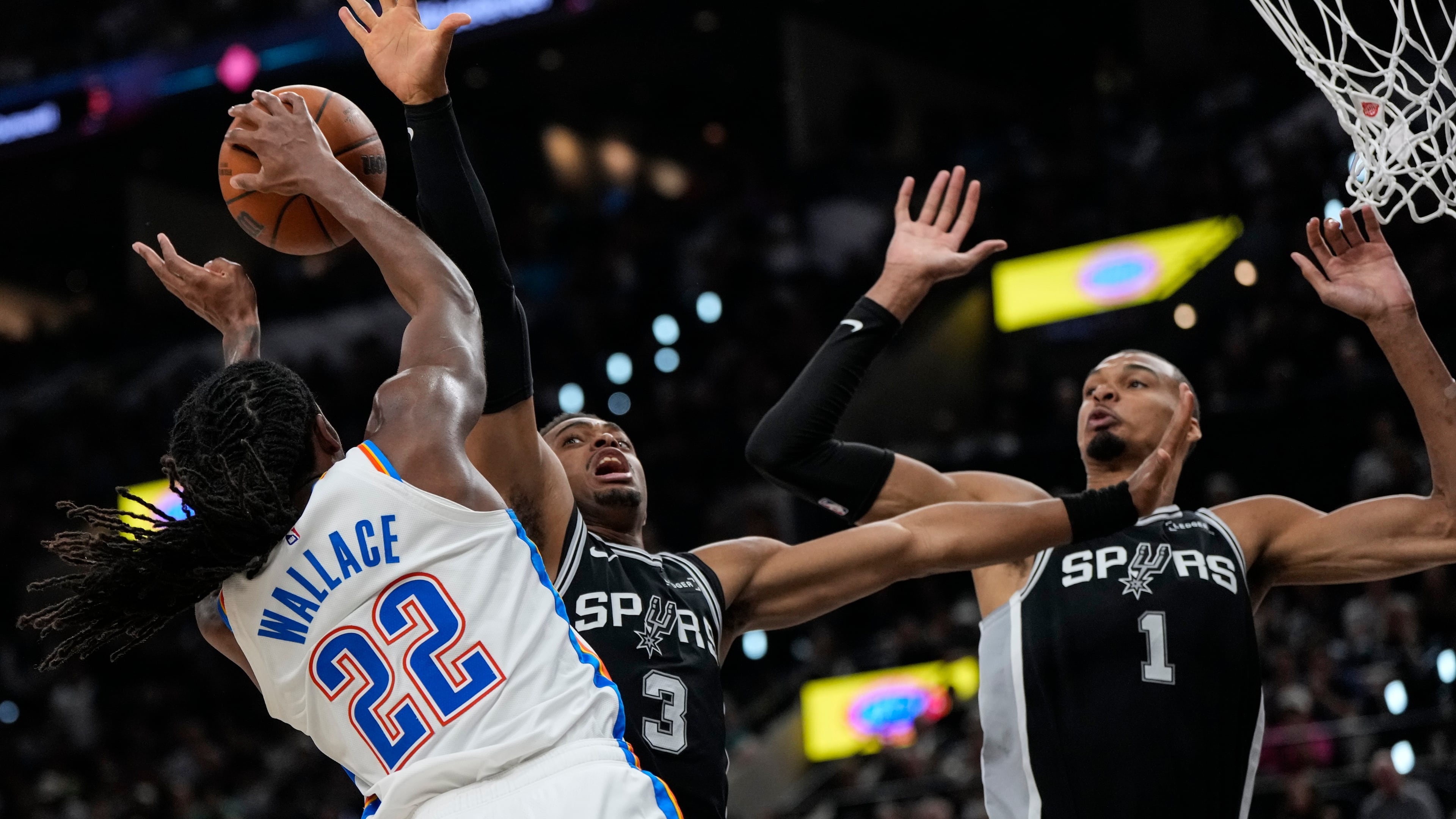 Oklahoma City Thunder guard Cason Wallace (22) shoots against San Antonio Spurs forward Keldon Johnson (3) in the second half of Game 6 in the Western Conference finals NBA basketball playoffs series, Thursday, May 28, 2026, in San Antonio. (AP Photo/David J. Phillip)