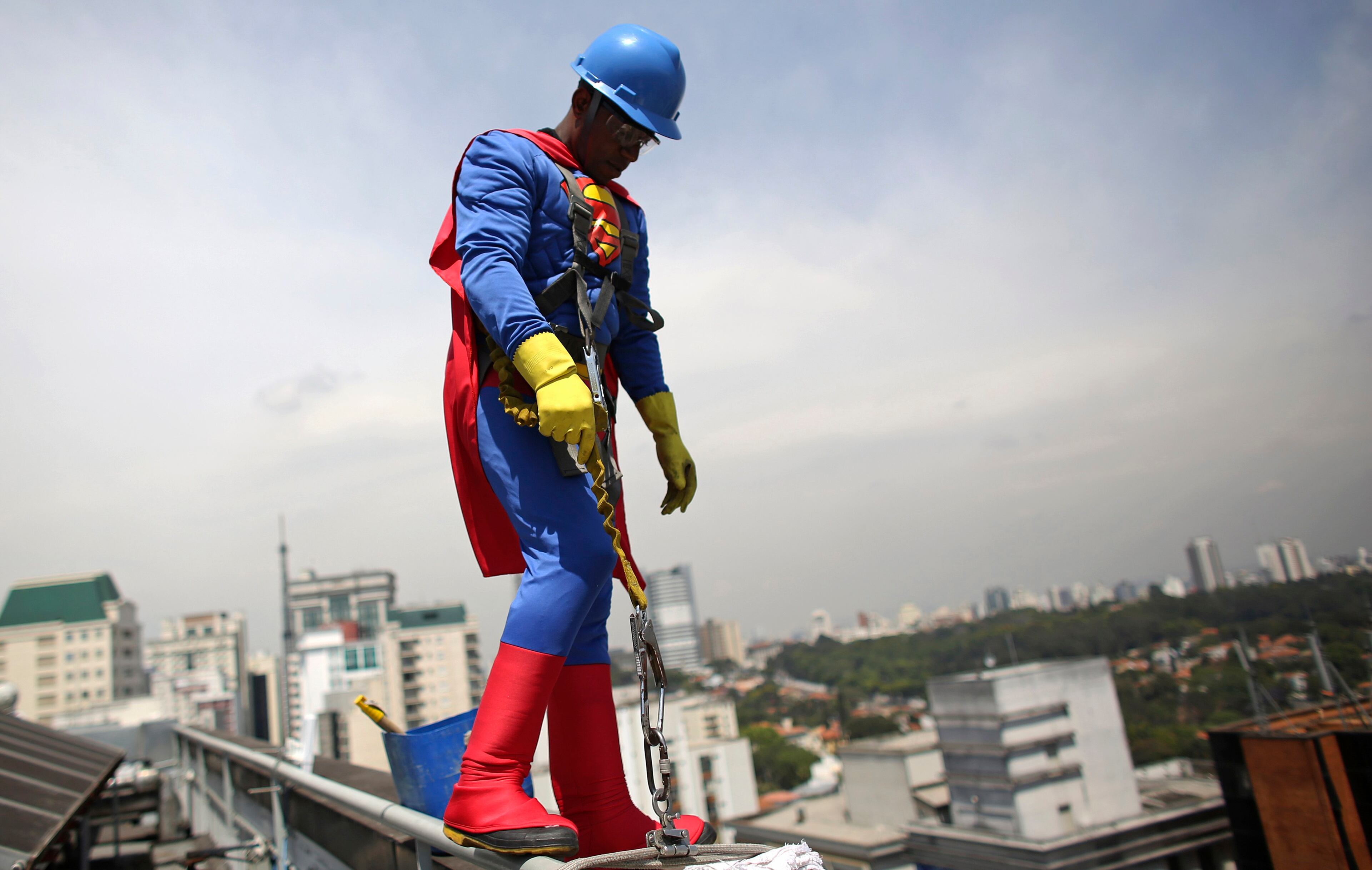 A man dressed as Superman prepares to clean the glass facade of Hospital Infantil Sabara before meeting with patients of the children's hospital in Sao Paulo October 11, 2013. Brazil celebrates Children's Day on October 12. REUTERS/Nacho Doce